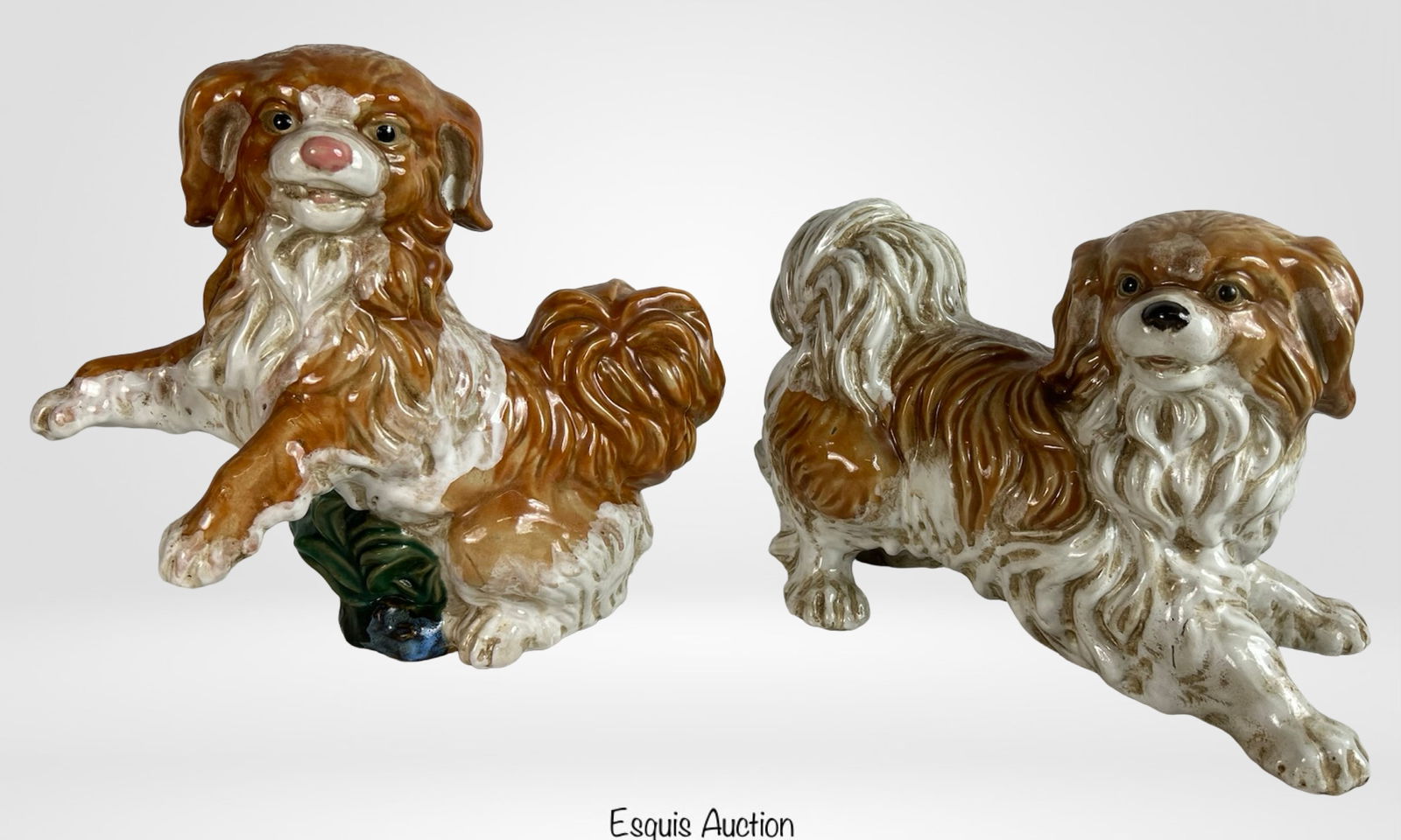 King Charles Cavalier Cermaic Dog Figurines: Charming pair of hand-painted ceramic figurines depicting King Charles Cavalier dogs in expressive, animated poses. Each features detailed fur texture with a rich brown and white glaze and lifelike fa