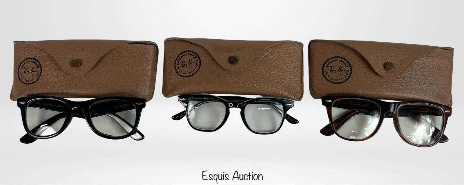 Group of Vintage Ray-Ban Eyeglasses: Three pairs of vintage Ray-Ban eyeglasses, each accompanied by its original brown leather protective case. Pre-owned condition.
