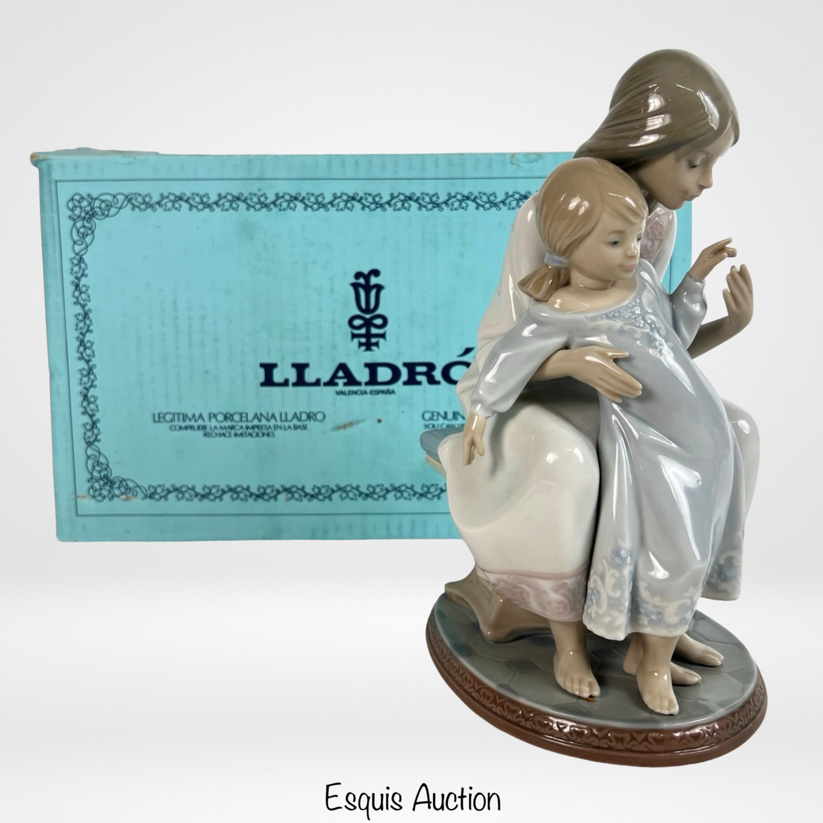 Lladro "Tenderness" 1527 Porcelain Figurine: Lladro porcelain figurine titled "Tenderness" (#1527) depicting a seated mother lovingly embracing her young daughter. Rendered in Lladro's signature soft pastel palette with fine hand-painted details