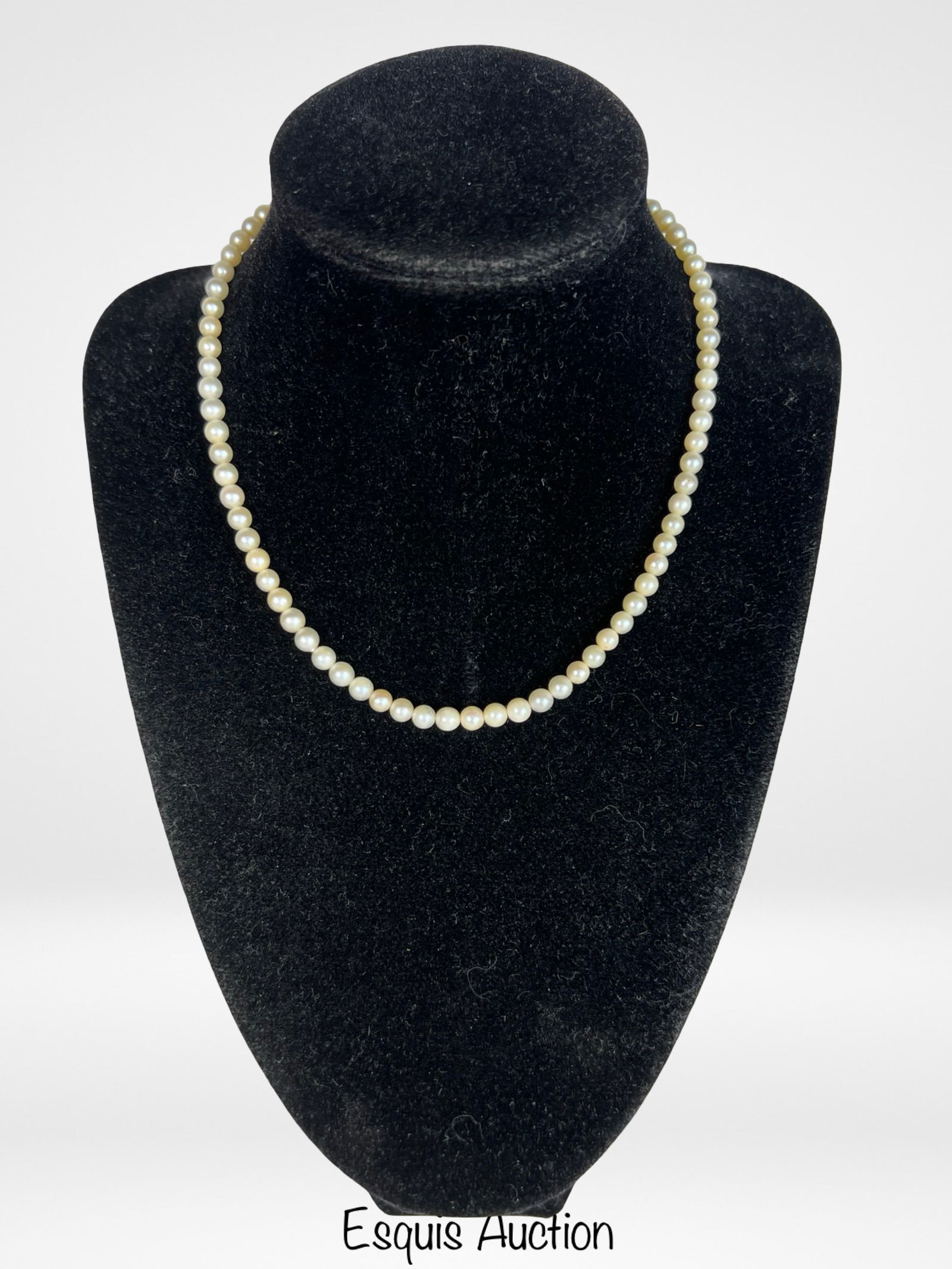 Genuine Pearl Necklace with 14K White Gold Clasp: Elegant strand of genuine cultured pearls, measuring approximately 14" in length, finished with a finely detailed 14K white gold clasp. A timeless and classic accessory, perfect for both everyday eleg