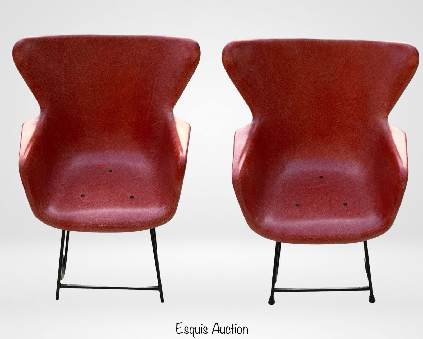 Lawrence Peabody MCM Wingback Fiberglass Chairs: Pair of Lawrence Peabody wingback chairs, circa mid-20th century, featuring molded fiberglass shells in a rich red tone with iron bases accented by scrollwork details. These striking Mid-Century Moder