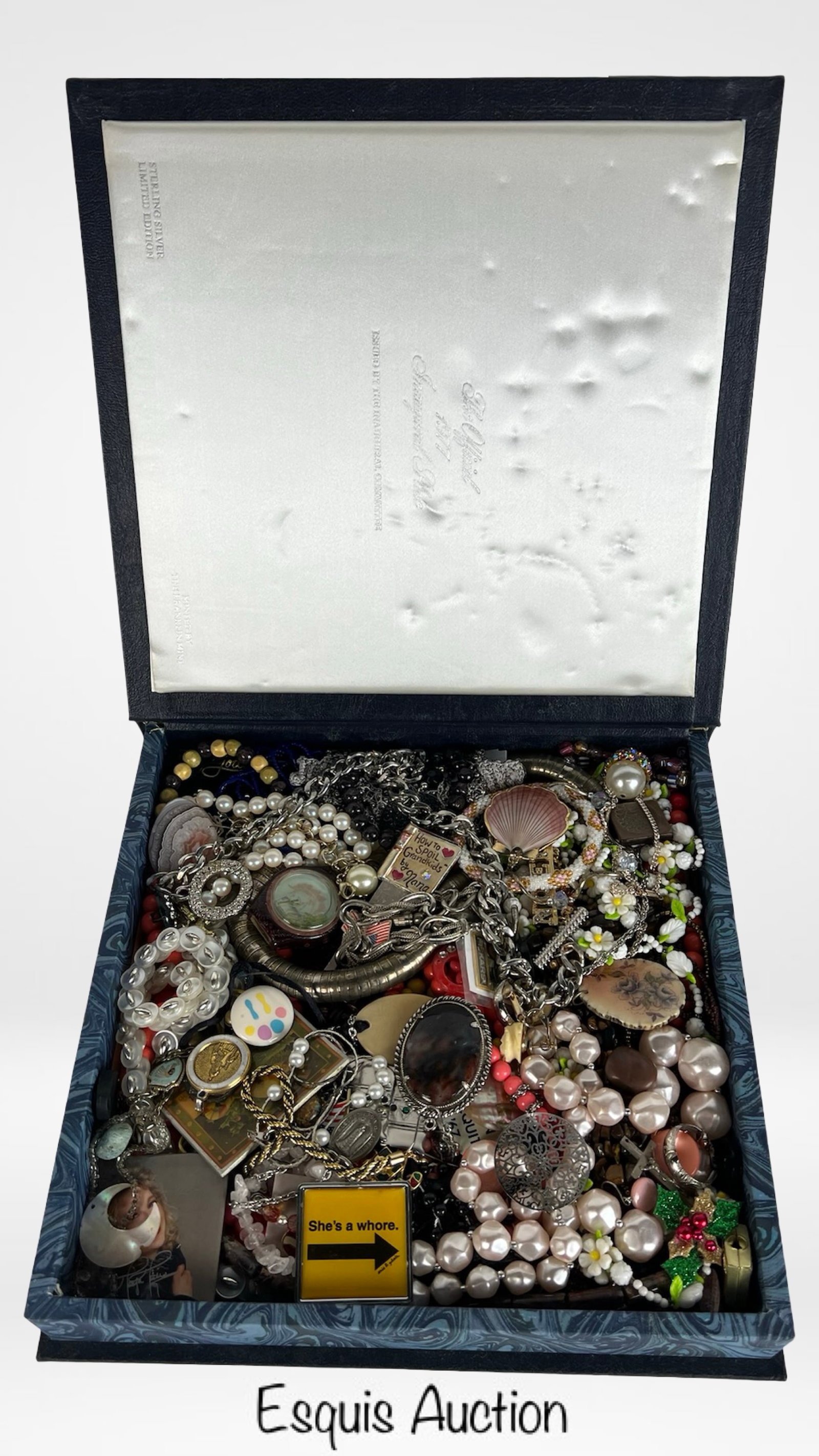 Vintage Box of Unsearched Costume & Craft Jewelry: An intriguing vintage box packed full of unsearched costume and craft jewelry, offering the thrill of discovery with every piece. Inside is a diverse assortment that includes necklaces, bracelets, bro