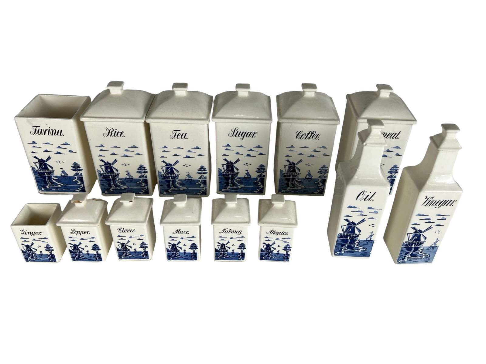 Antique German Kitchen Spice Canister Set: A charming early 20th century German porcelain kitchen canister set, decorated with iconic blue-and-white Delft-style windmill scenes. The set includes large canisters labeled Farina, Rice, Tea, Sugar