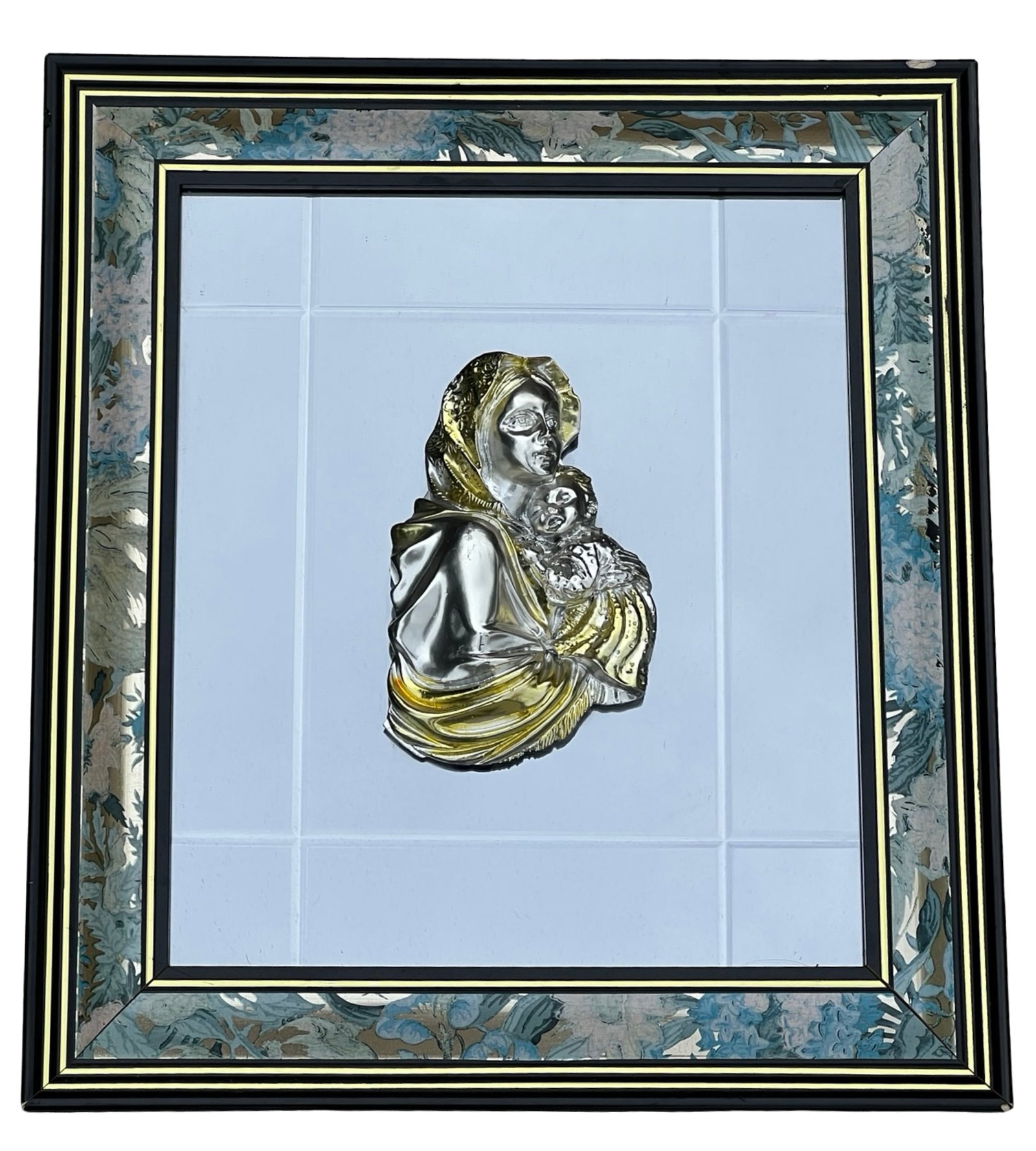 Italian Madonna & Child Sterling Wall Plaque: Beautifully crafted Italian wall plaque depicting the Madonna and Child, rendered in relief with sterling-covered detailing and gilt highlights. Set against a mirrored background within a decorative f