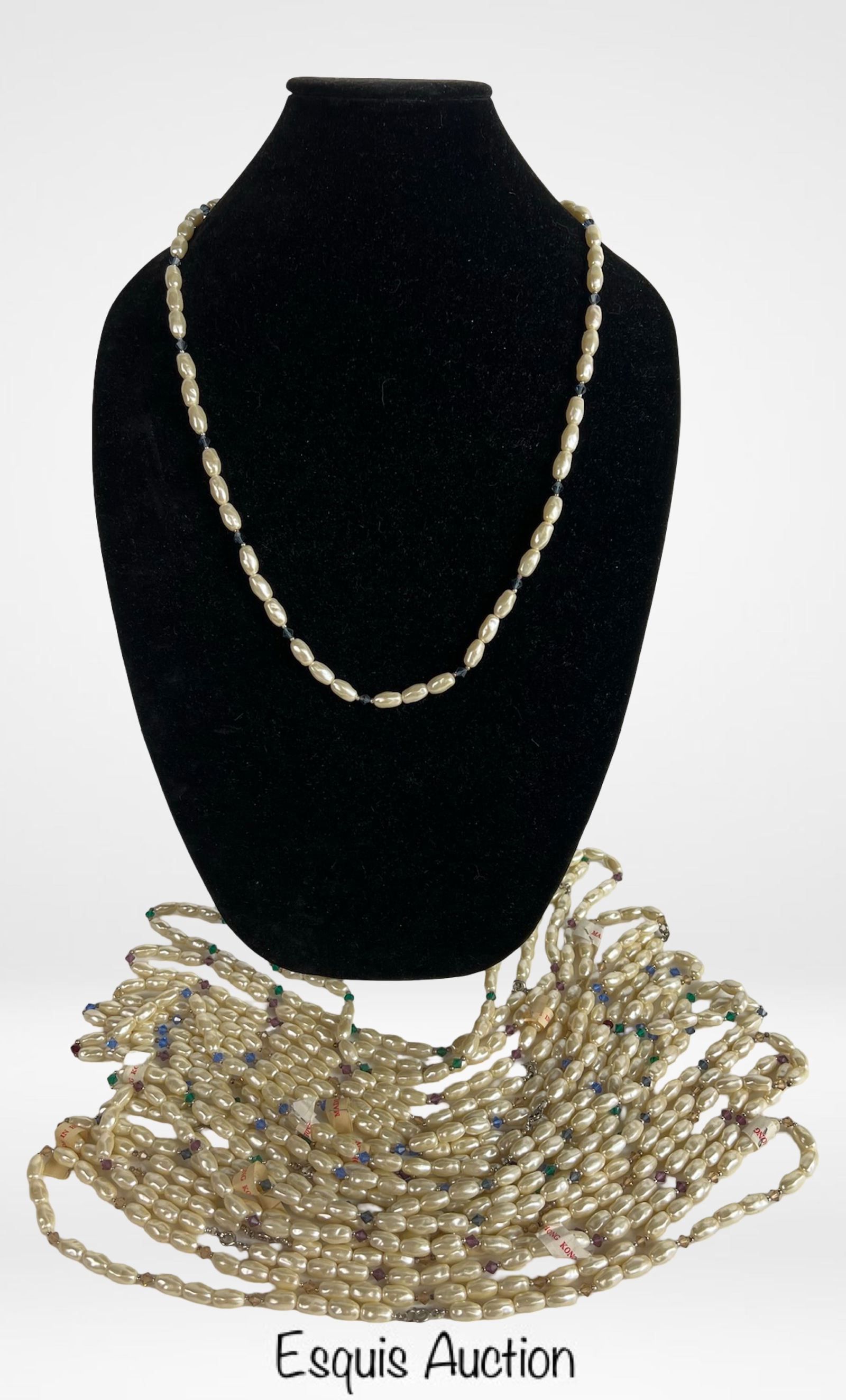 One Dozen Genuine Pearl Necklaces Gemstone Accents: Lot of twelve (12) new old stock genuine pearl necklaces, each featuring lustrous elongated pearls accented with colorful gemstone beads in shades of green, blue, and purple. Classic and elegant desig