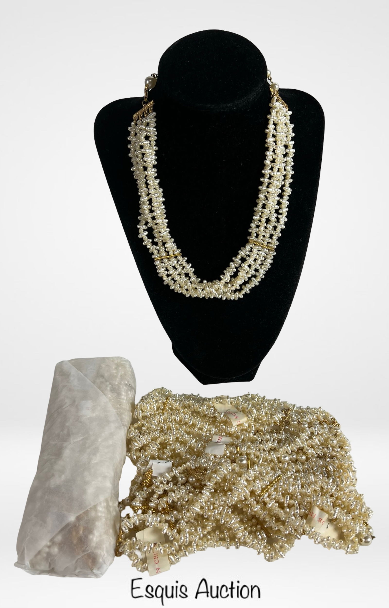 Dozen Faux Pearl Multi-Strand Costume Necklaces: Lot of twelve (12) vintage new old stock multi-strand costume jewelry necklaces, each crafted with luminous faux pearls arranged in an elegant layered design. Accented with gold-tone findings, these n