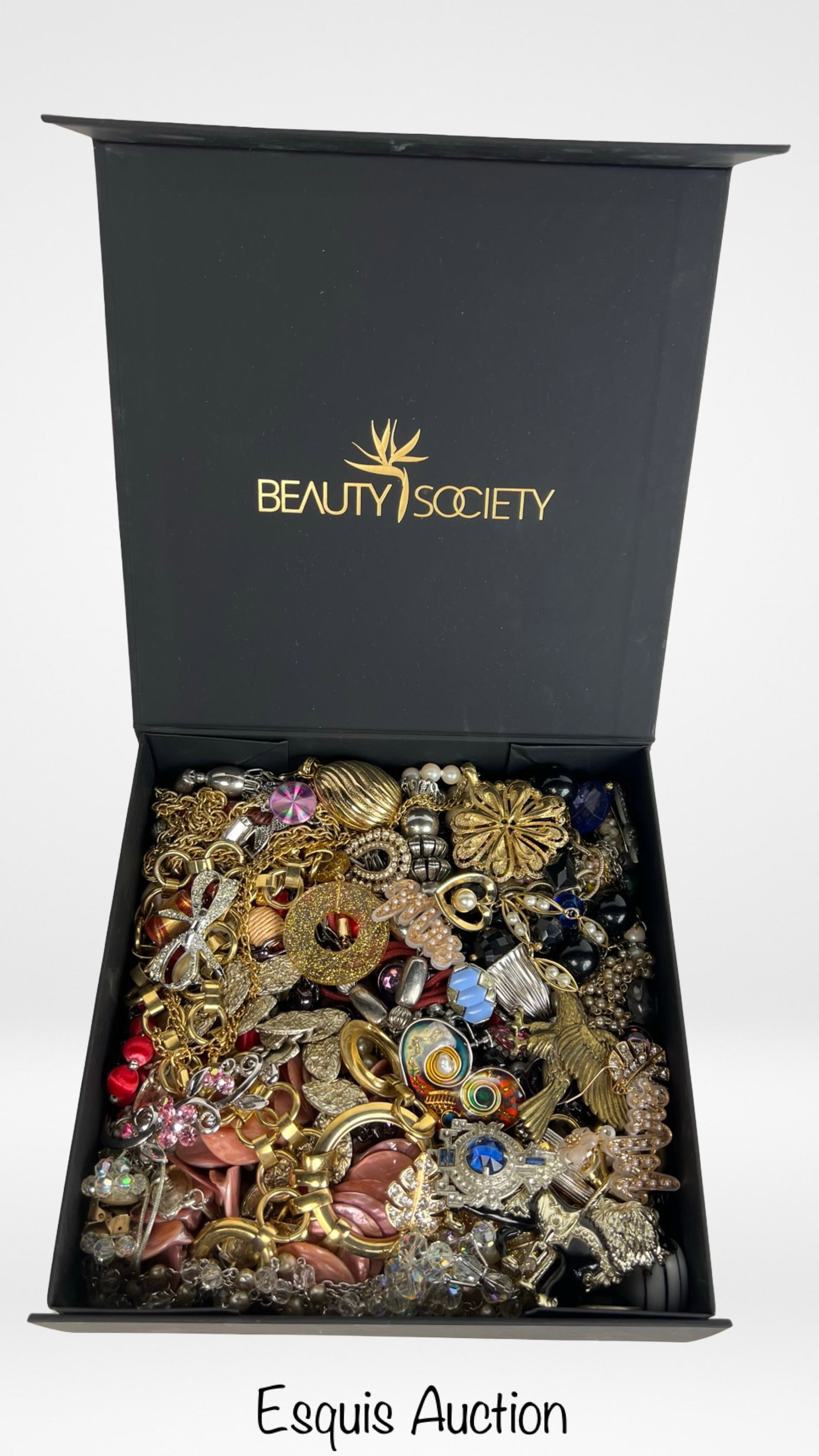 Box filled with Vintage Unsearched Costume Jewelry: A charming assortment of vintage, unsearched costume and craft jewelry awaits, filled with creative potential and nostalgic appeal. The collection offers a wide variety of styles, colors, and material
