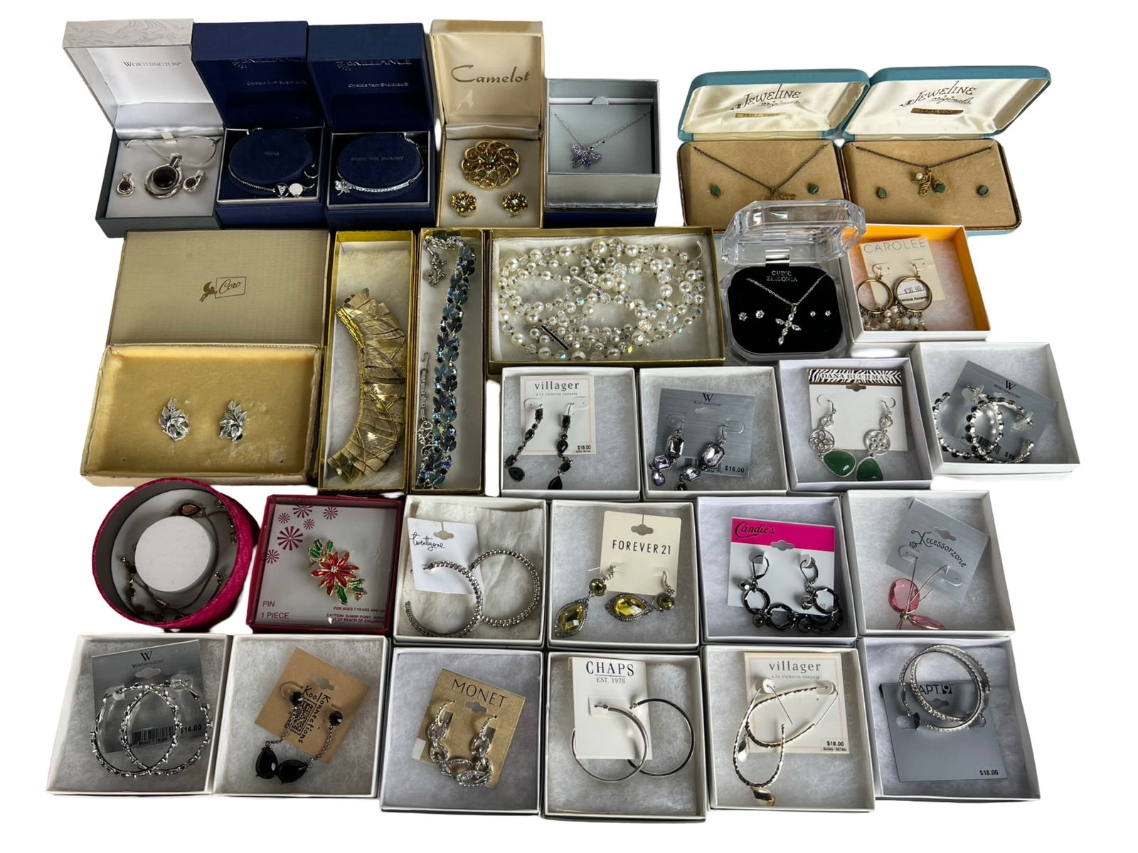 Assortment of Costume & Fashion Jewelry in Boxes: Large mixed lot of women's costume and fashion jewelry, including earrings, bracelets, brooches, necklaces, and pins. Brands represented include Monet, Coro, Carolee, Chaps, Villager (Liz Claiborne),