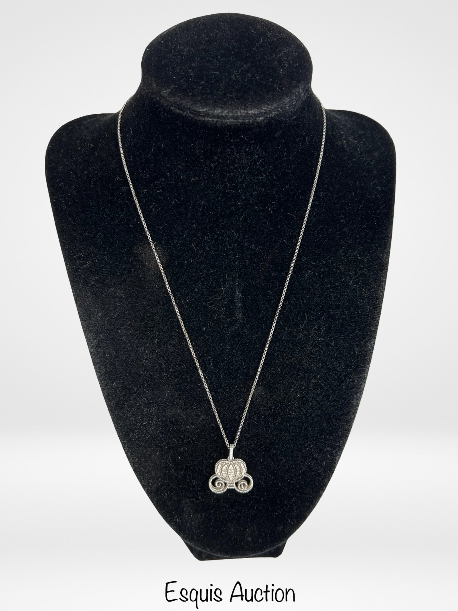Disney 18k Gold Cinderella Carriage Necklace: Elegant Disney Cinderella carriage pendant crafted in 18k white gold, beautifully accented with sparkling diamonds. The whimsical pumpkin coach design is finely detailed with rope-textured gold and di
