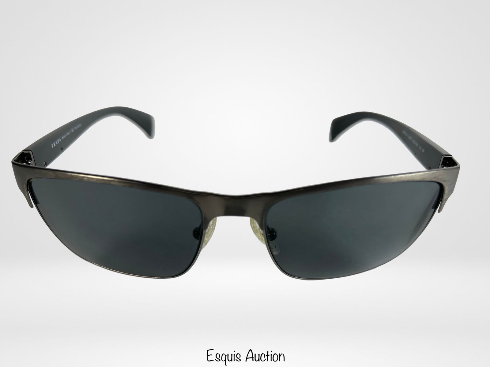 Prada SPR510 Designer Sunglasses: Sleek and modern, these Prada SPR510 designer sunglasses feature a streamlined rectangular frame crafted from brushed gunmetal with glossy black arms. Good pre-owned condition with minimal surface wea