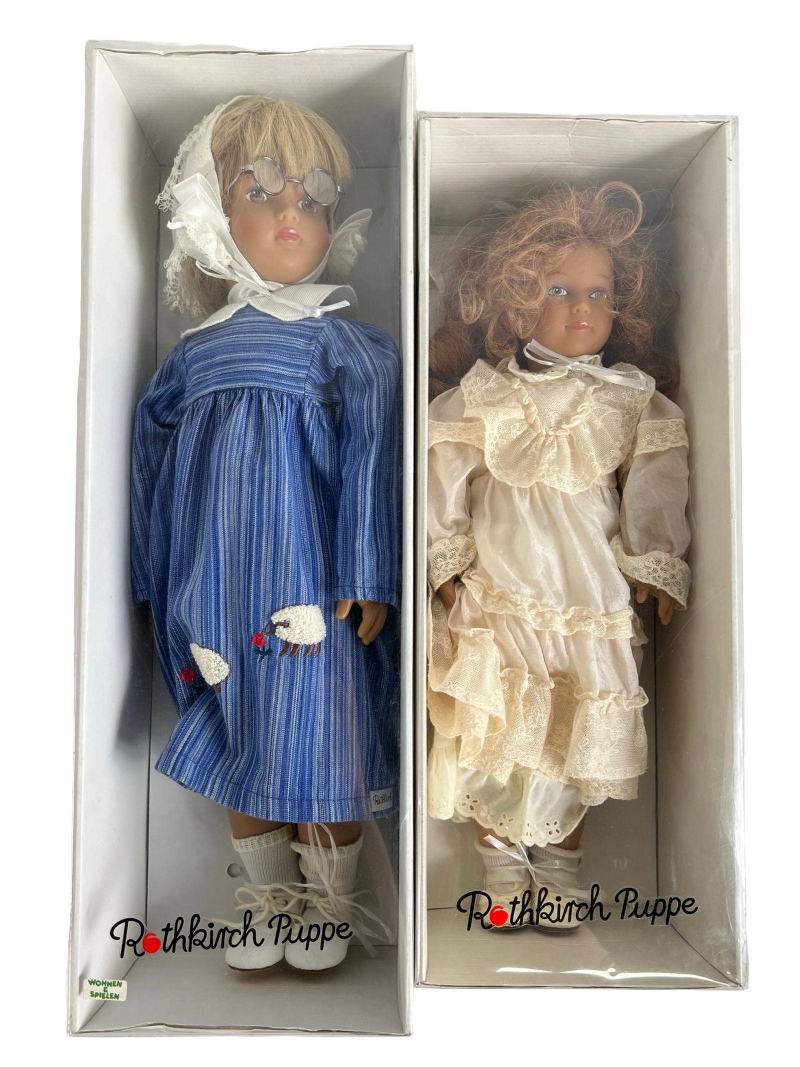 Rothkirch Puppe German Artist Dolls: Charming duo of Rothkirch Puppe dolls, handcrafted in Germany with lifelike expressions and beautifully detailed clothing. Includes one 19" doll in a blue striped dress with glasses and embroidered sh