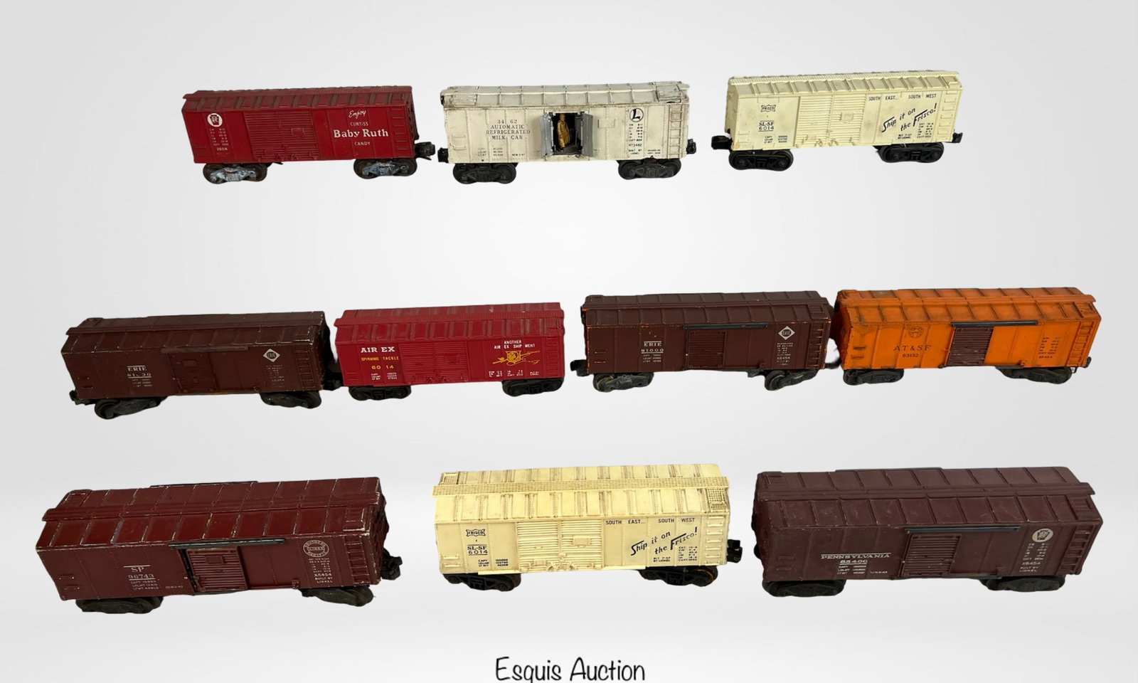 Lot of 10 Lionel O Gauge Train Boxcars: Group of 10 vintage Lionel O gauge boxcars featuring a variety of liveries and advertising graphics. Includes "Curtiss Baby Ruth" red boxcar, two variations of "Ship the Frisco" reefers, "Air EX Phone