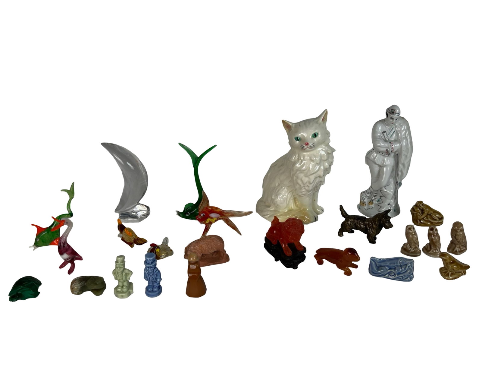 Assorted Figurines: Baccarat, Goebel, Wade,: Eclectic group of collectible figurines and sculptures, including a Baccarat clear crystal crescent moon paperweight, Goebel West Germany large Persian cat figurine, and a Romanian glazed shepherd fig