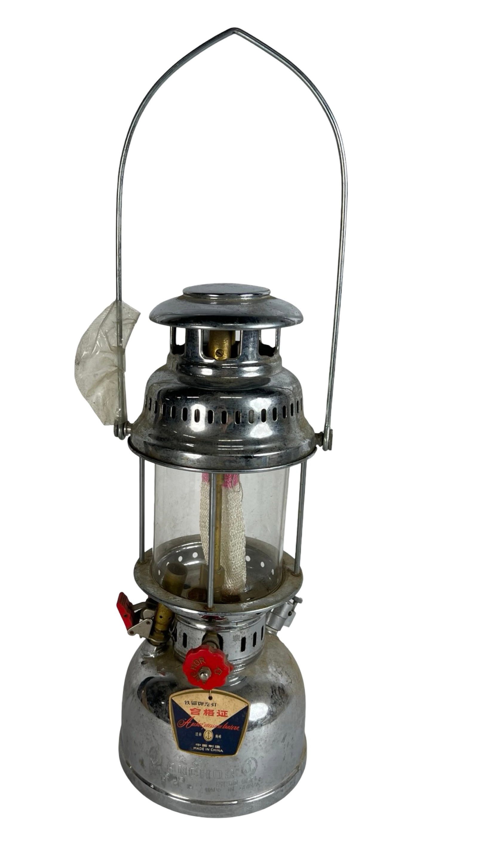 Vintage Anchor No. 909 Pressure Lantern Lamp: Classic Anchor No. 909 kerosene pressure lantern, crafted in polished metal with red control knobs and glass globe. Retains its original embossed Anchor trademark and label.