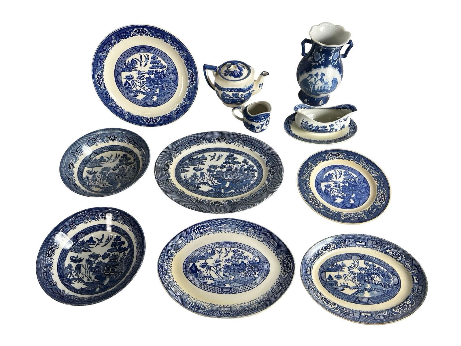 Vintage Blue Willow Ceramic Serving & Tableware: Charming assortment of vintage Blue Willow patterned ceramic dishes and serveware, produced by various manufacturers including Churchill and others. This classic cobalt blue and white group features a