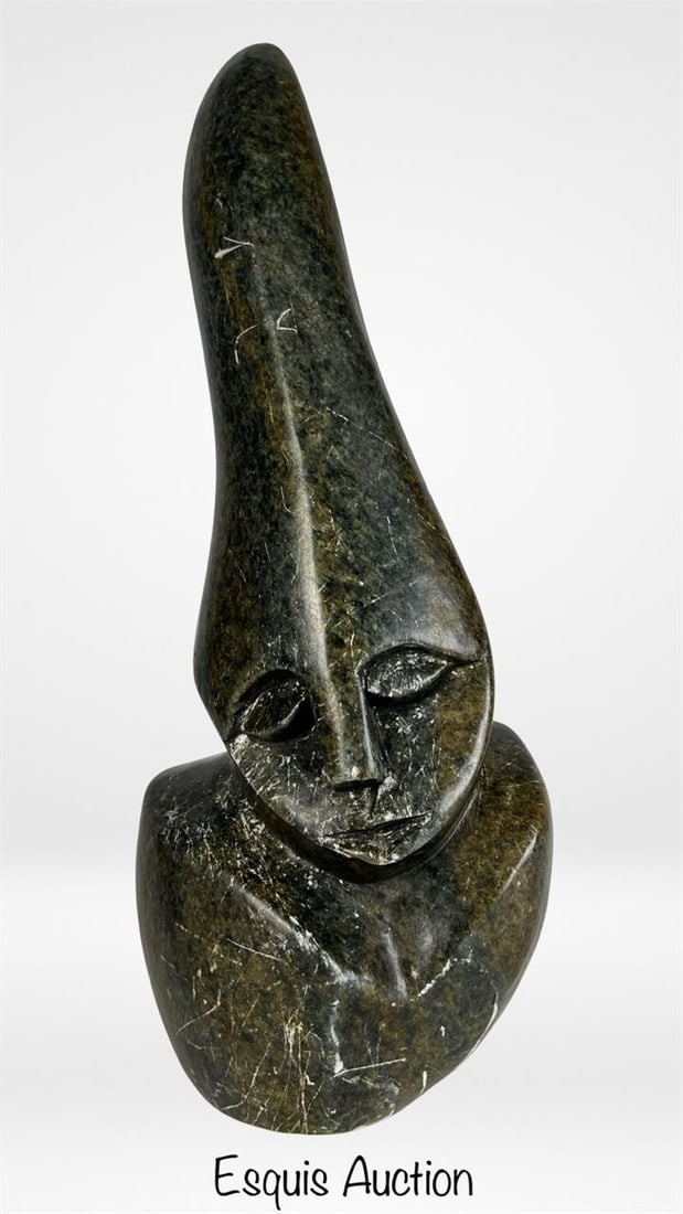 Hand Carved Stone Shona Serpentine Sculpture: Striking Shona sculpture carved by hand from dark green serpentine with natural lighter veining and a glossy polish. The stylized bust features an elongated tapering head and serene closed eyes-hallma