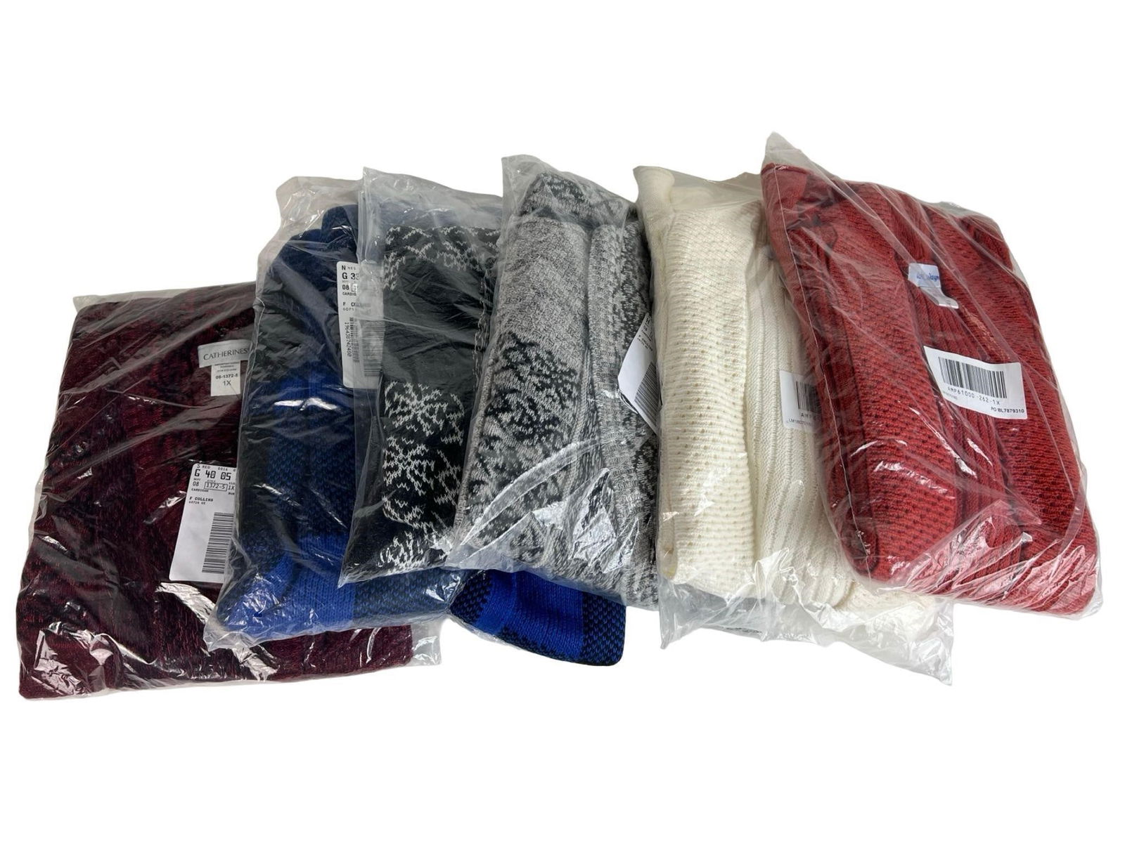 Lot of Women's Plus Size Open Front Cardigans: Assortment of women's plus size cardigans in various styles and colors, including red, burgundy, blue/black geometric, cream, and gray patterned designs. Each features an open-front drape with cozy kn