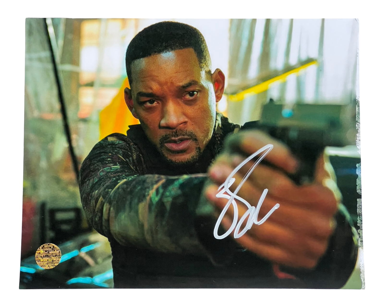Will Smith Signed/ Autographed Photograph: Dynamic color photograph signed by Will Smith, capturing him in an intense action scene with firearm drawn. This piece is a true highlight for Hollywood memorabilia collectors and Will Smith fans alik