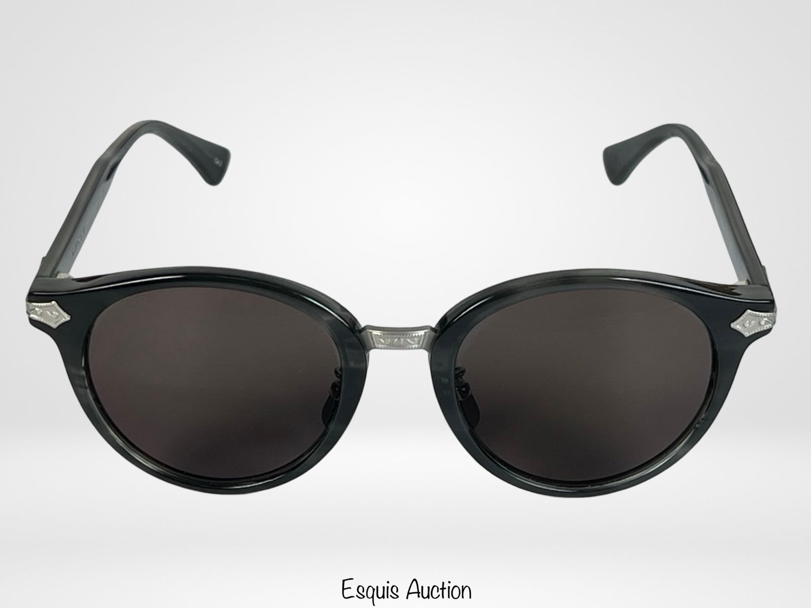 Gucci GG0066S Titanium Round Sunglasses: Sophisticated Gucci GG0066S round sunglasses crafted from lightweight titanium, featuring sleek black frames with dark lenses.Good pre-loved condition.