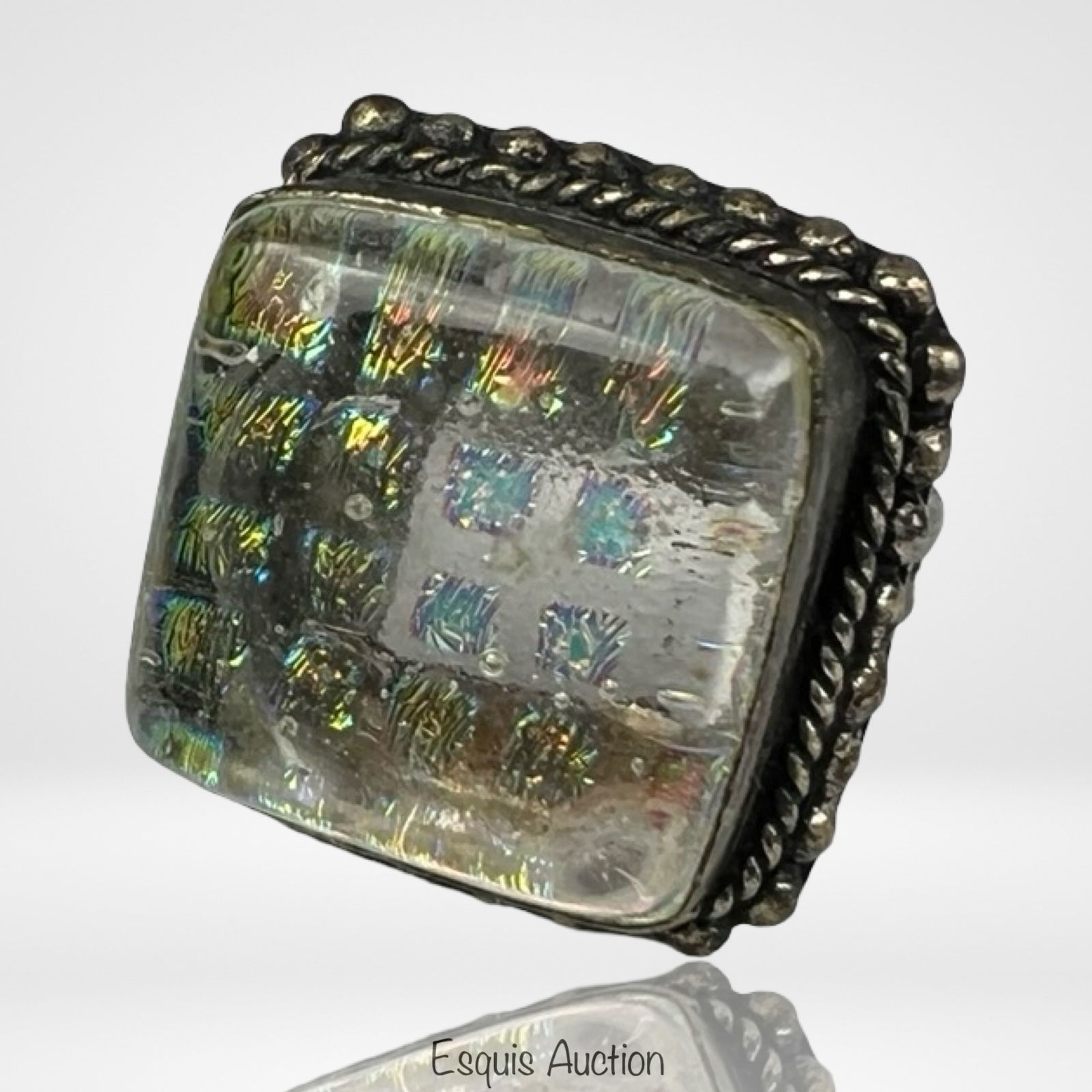 Sterling Silver Ring with Art Glass Inset: Vintage sterling silver ring showcasing a large square art glass cabochon with iridescent rainbow hues and bubble inclusions, framed in a detailed beaded and rope border. Ring size 9.25.
