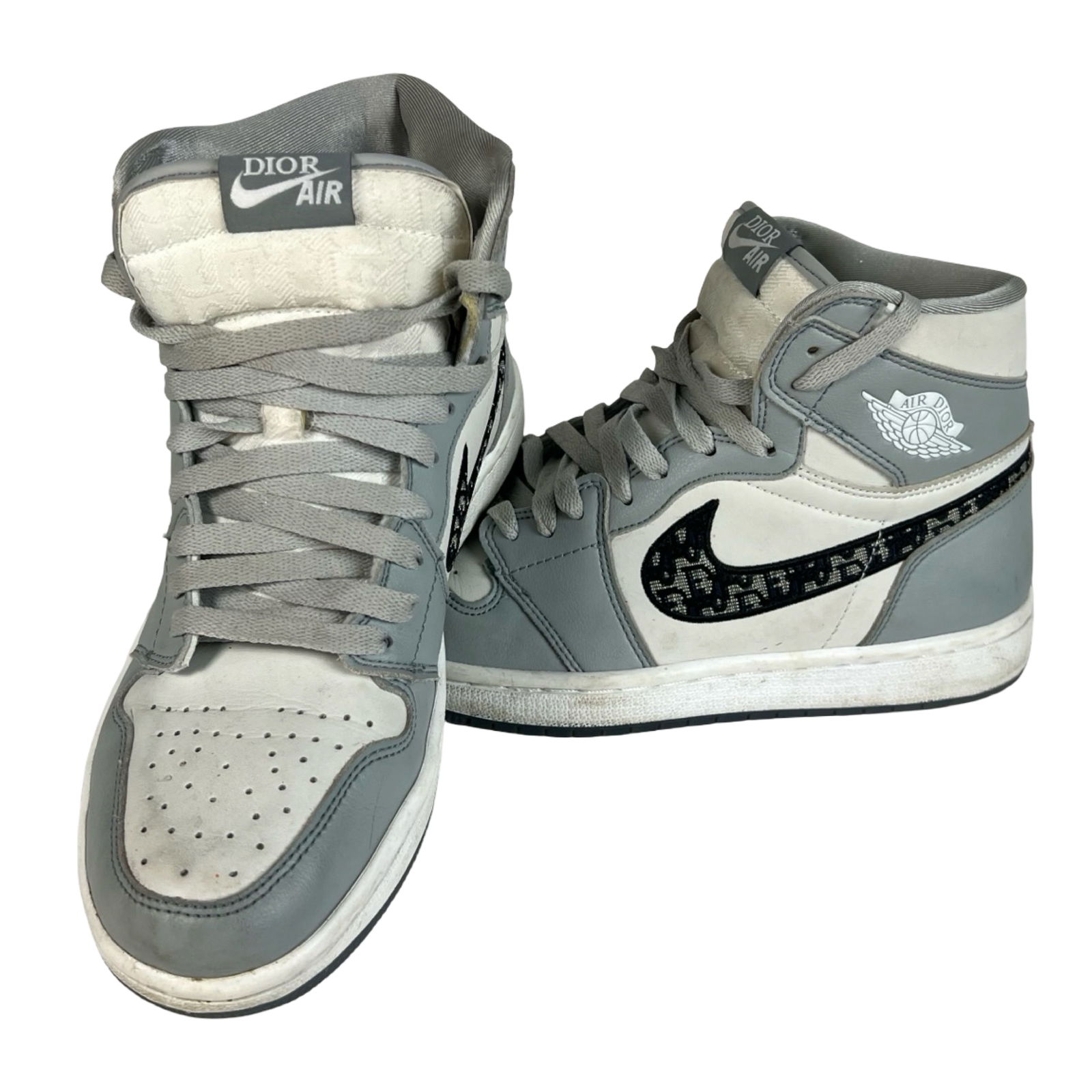 High-Top Gray & White Sneakers Size- 8: A pair of stylish high-top sneakers featuring a gray and white color scheme with a patterned side swoosh design. The translucent outsoles reveal bold lettering beneath, adding a unique detail to the o