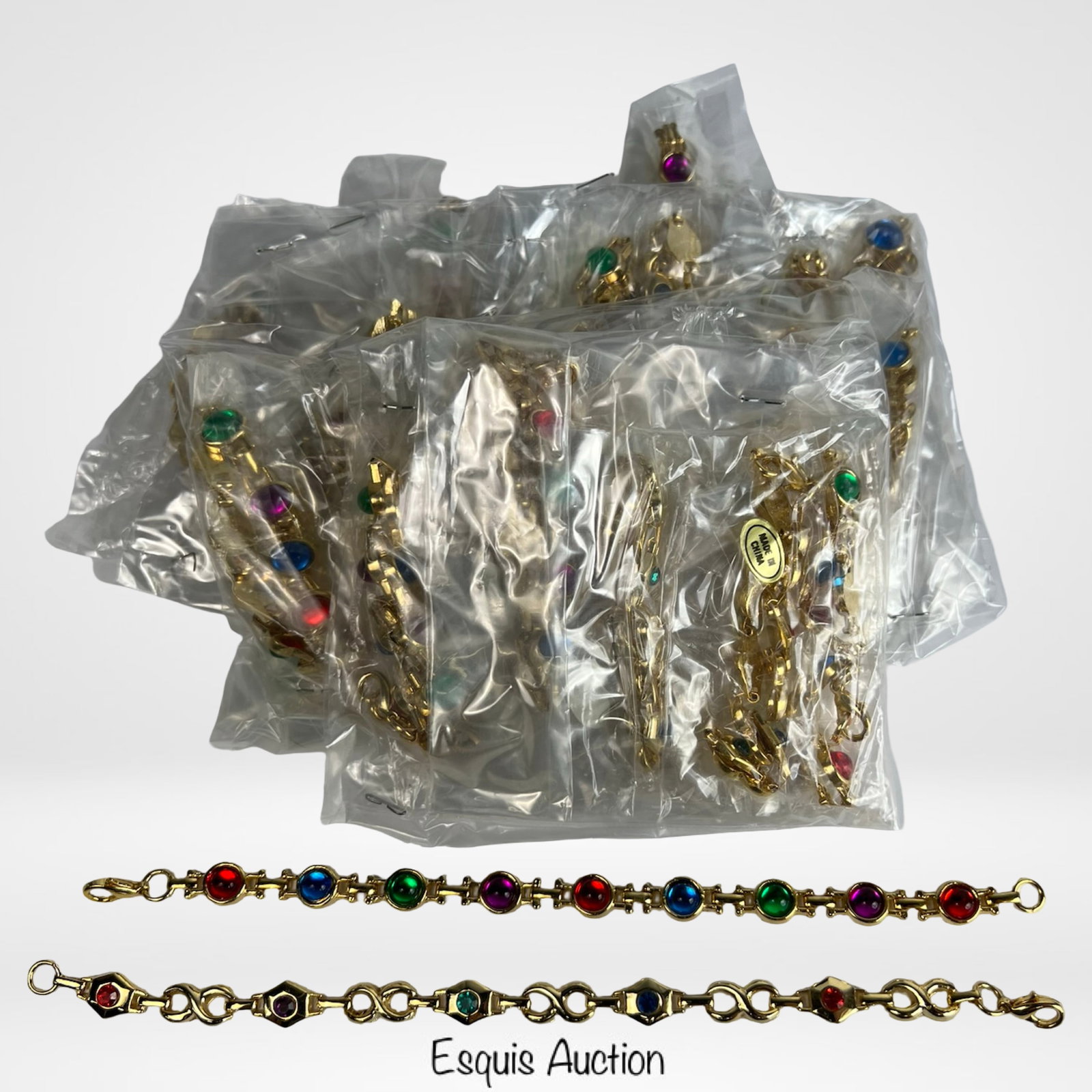 24 Vintage Multi-Color Glass Stone Link Bracelets: Set of two dozen vintage link bracelets adorned with round and geometric glass stones in rich, vibrant hues of red, green, blue, and purple. Each bracelet features a stylish chain design with colorful