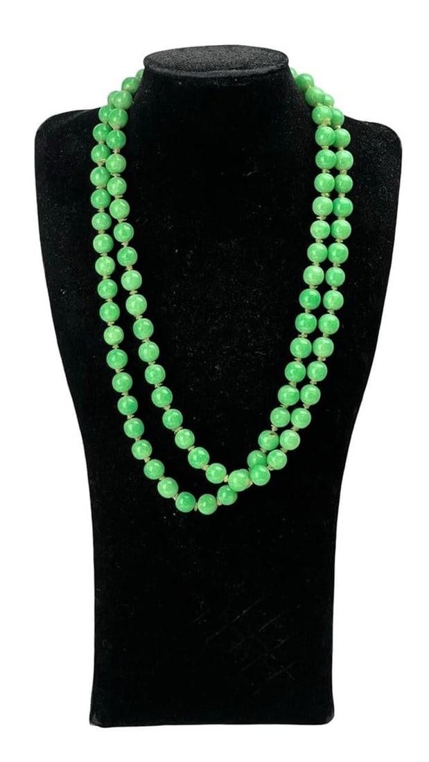 Vintage Chinese Green Jade Beads Necklace, 44": This vintage Chinese jade necklace features a strand of vibrant green jade beads, each carefully hand-knotted for added security and elegance. The rich, translucent green hue reflects the prized quali