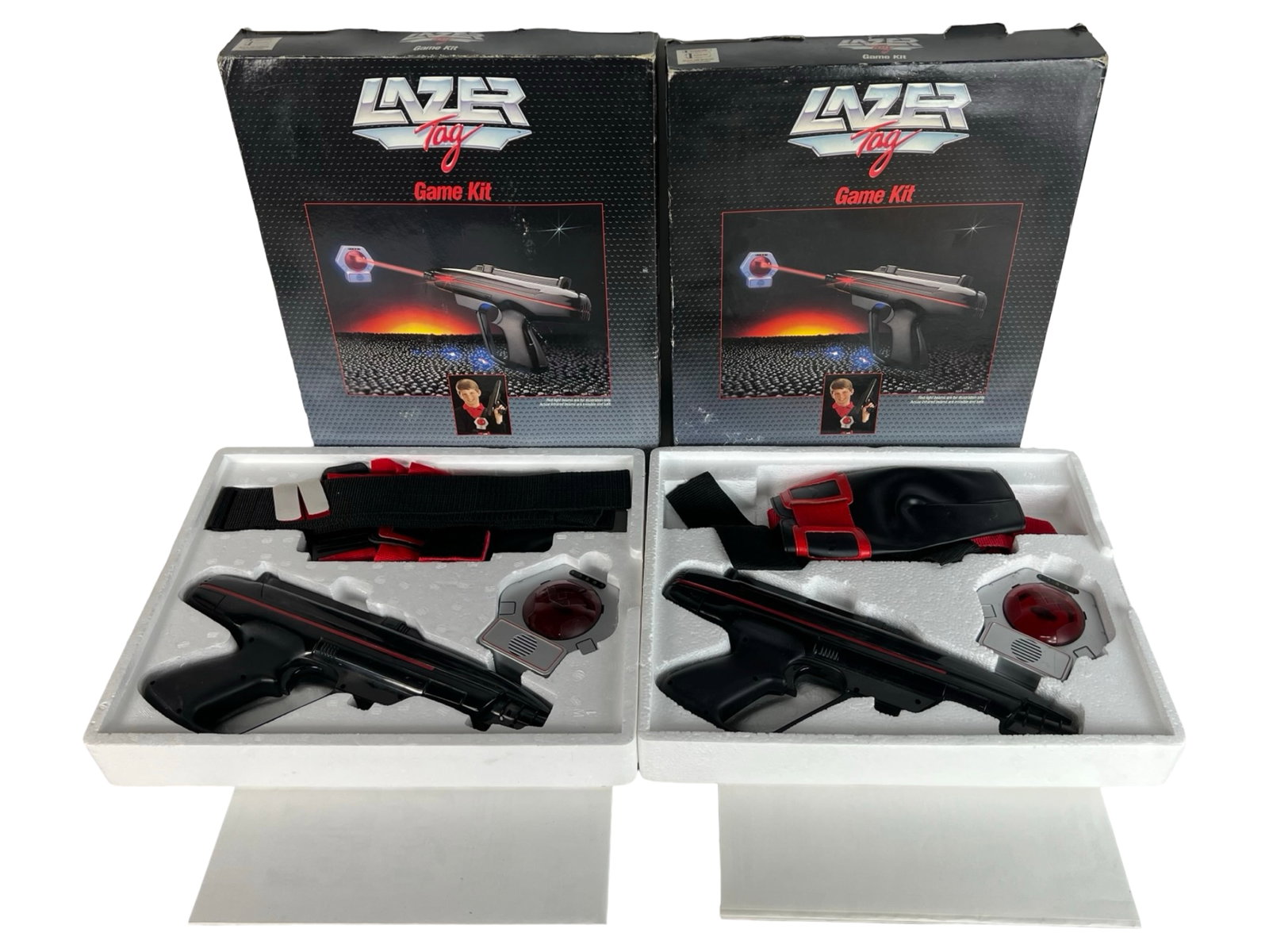 2 Worlds of Wonder "Lazer Tag" Game Kits (1986): Pair of original 1986 Worlds of Wonder "Lazer Tag" Game Kits, the iconic 1980s infrared battle system that lets players tag opponents with light beams. Each boxed set includes a starlite pistol, senso