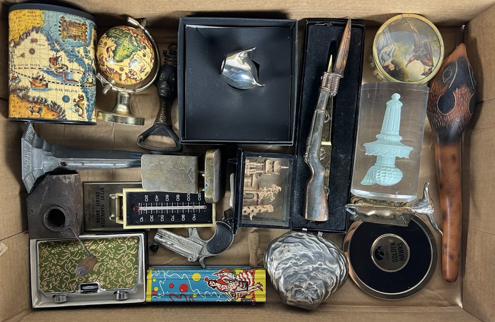 Vintage Curios, Desk Items & Miniatures: Eclectic collection of vintage curios and novelty items, including a brass globe, miniature globe tin, "Golden Hawks" letter opener, cast metal bull, scenic letter opener, brass thermometer, carved wo