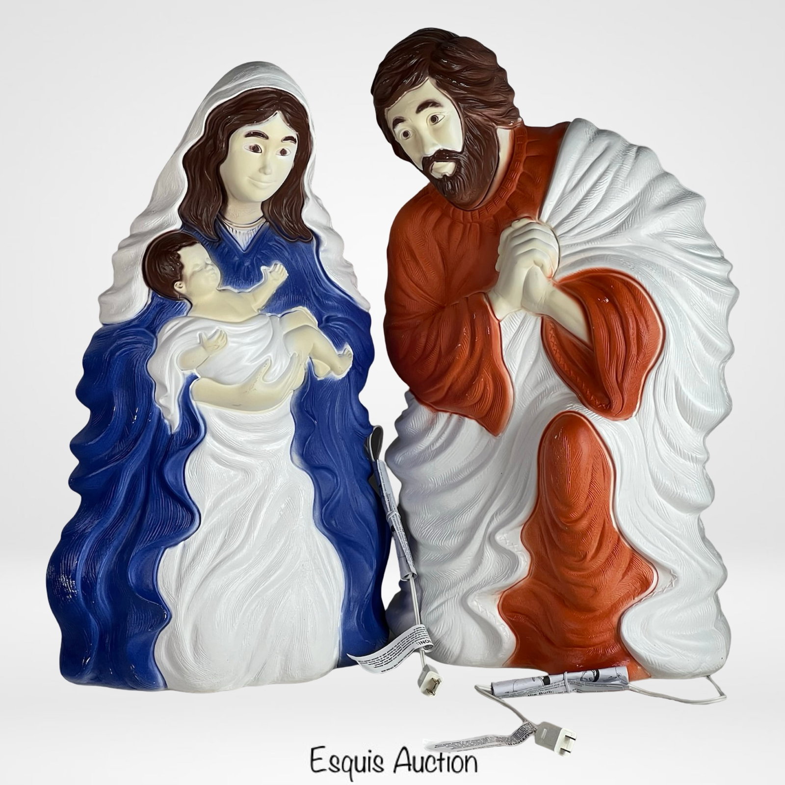 Christmas Holy Family Blow Mold Nativity Pair: Classic vintage-style blow mold nativity scene featuring Mary cradling baby Jesus and Joseph in prayer. Both figures measure approximately 26.5" tall and are designed with vibrant colors.Appears to be