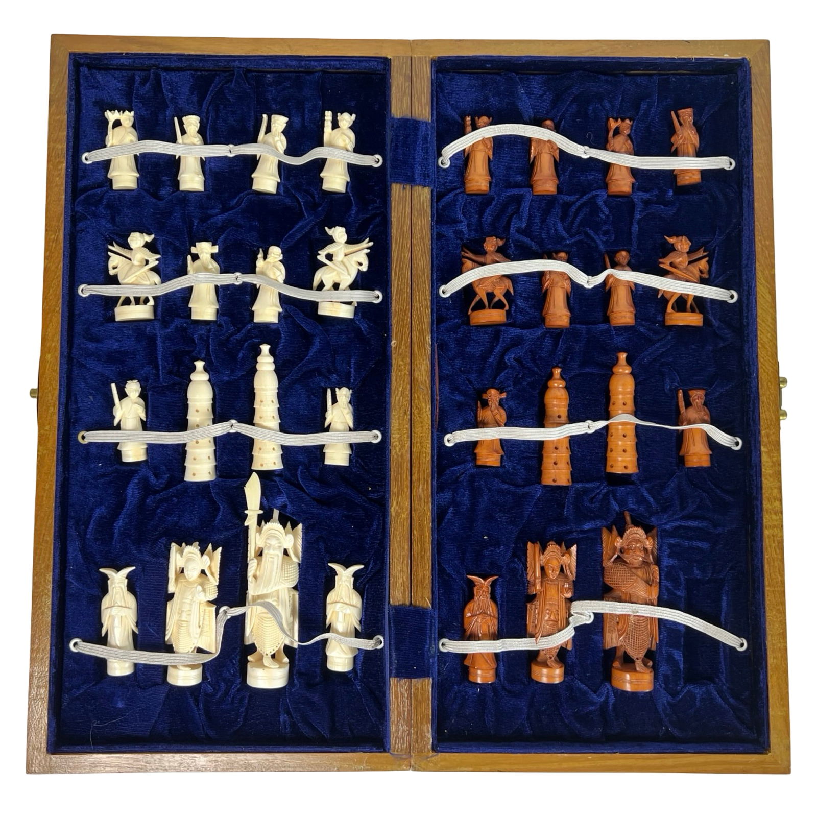 Chinese Warrior-Themed Carved Chess Set: Intricately carved chess set featuring an elaborate Chinese warrior motif, with two full armies in contrasting light and dark tones. Each piece is finely detailed, from the mounted knights to the pago