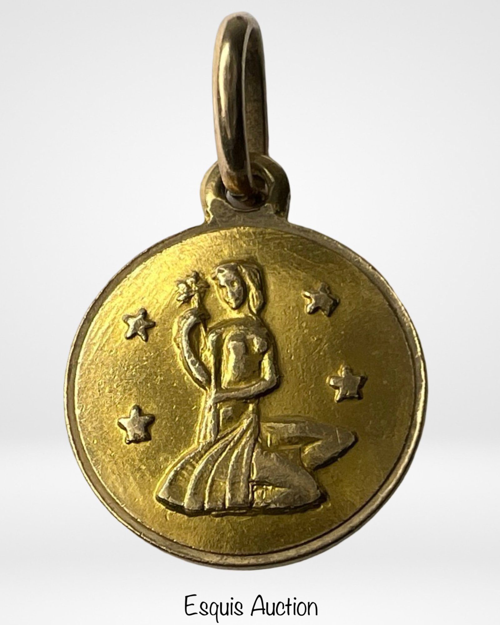 14K Yellow Gold Virgo Zodiac Pendant: Charming 14K yellow gold zodiac pendant depicting Virgo, represented by a kneeling maiden surrounded by stars. Finely detailed in relief, this Italian-made charm is stamped "14K ITALY" on the reverse.