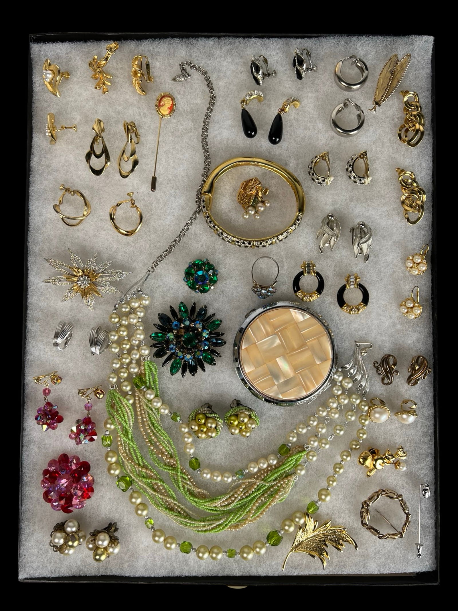 Vintage Costume Jewelry - Trifari, Lisner, Coro,: A vibrant and varied collection of vintage costume jewelry, showcasing an array of designer and unsigned pieces. Notable highlights include a Vinard 12k gold-filled brooch, multiple pairs of Crown Tri