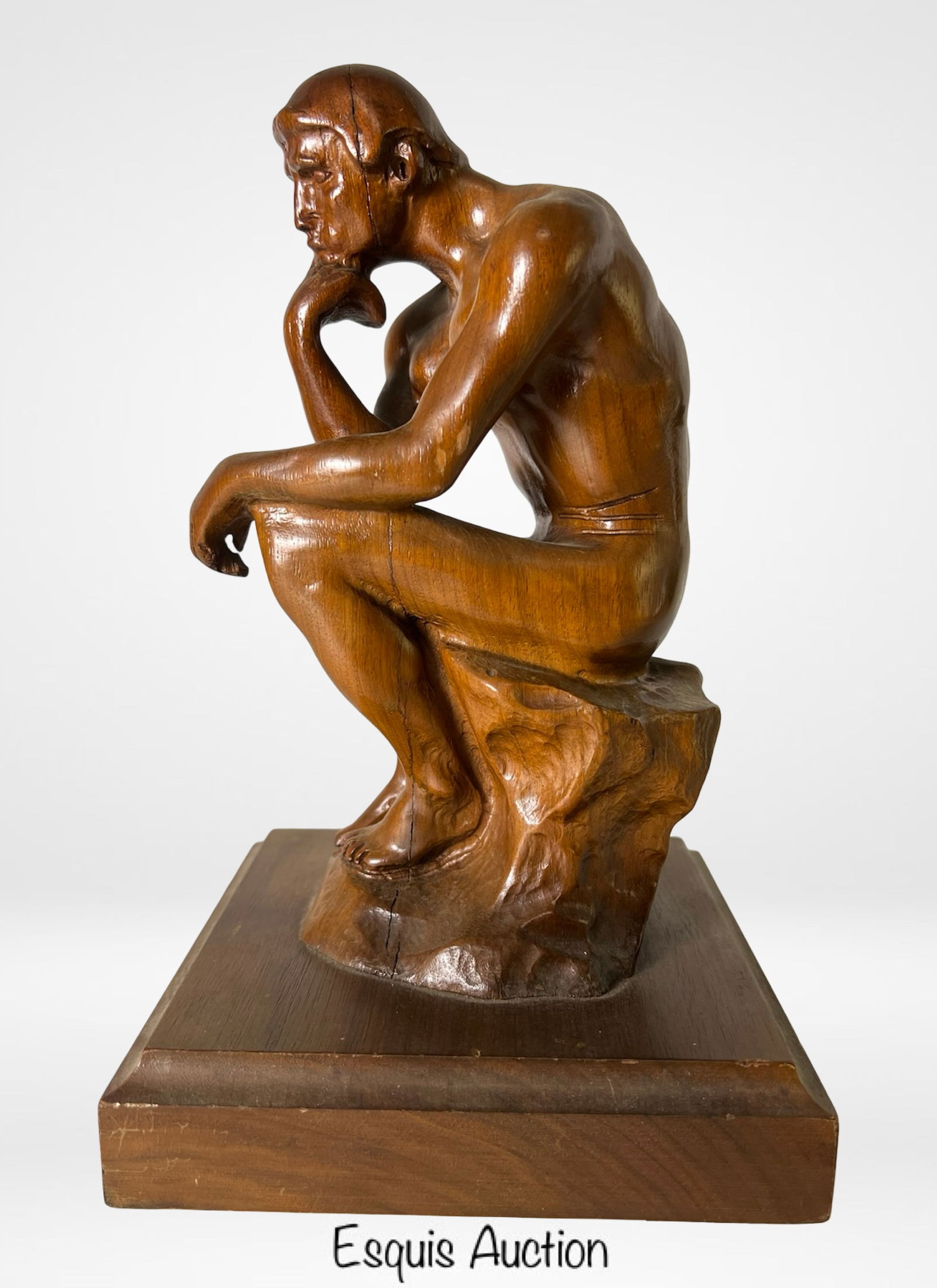 The Thinker" Hand-Carved Wood Sculpture: This expressive hand-carved wood sculpture pays homage to Auguste Rodin's iconic "The Thinker," capturing a nude male figure deep in contemplation with chin resting on hand. Rendered with careful anat