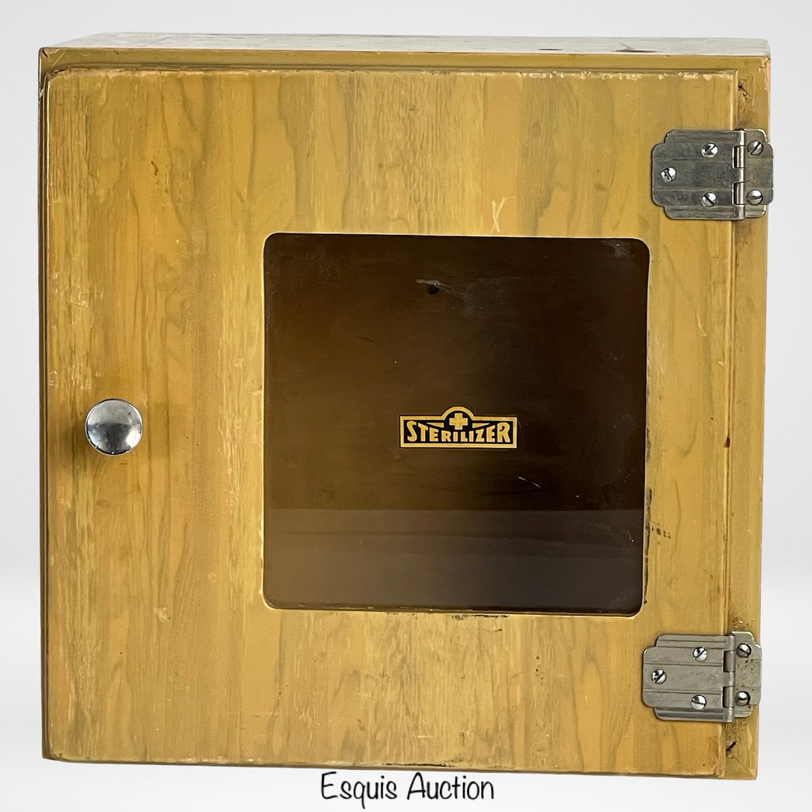Art Deco Era Wooden Sterilizer Cabinet: A vintage Art Deco period wooden sterilizer cabinet manufactured by Palco Mfg. Co. of Belvidere, Illinois. This functional cabinet features a hinged door with inset glass panel labeled "Sterilizer," m