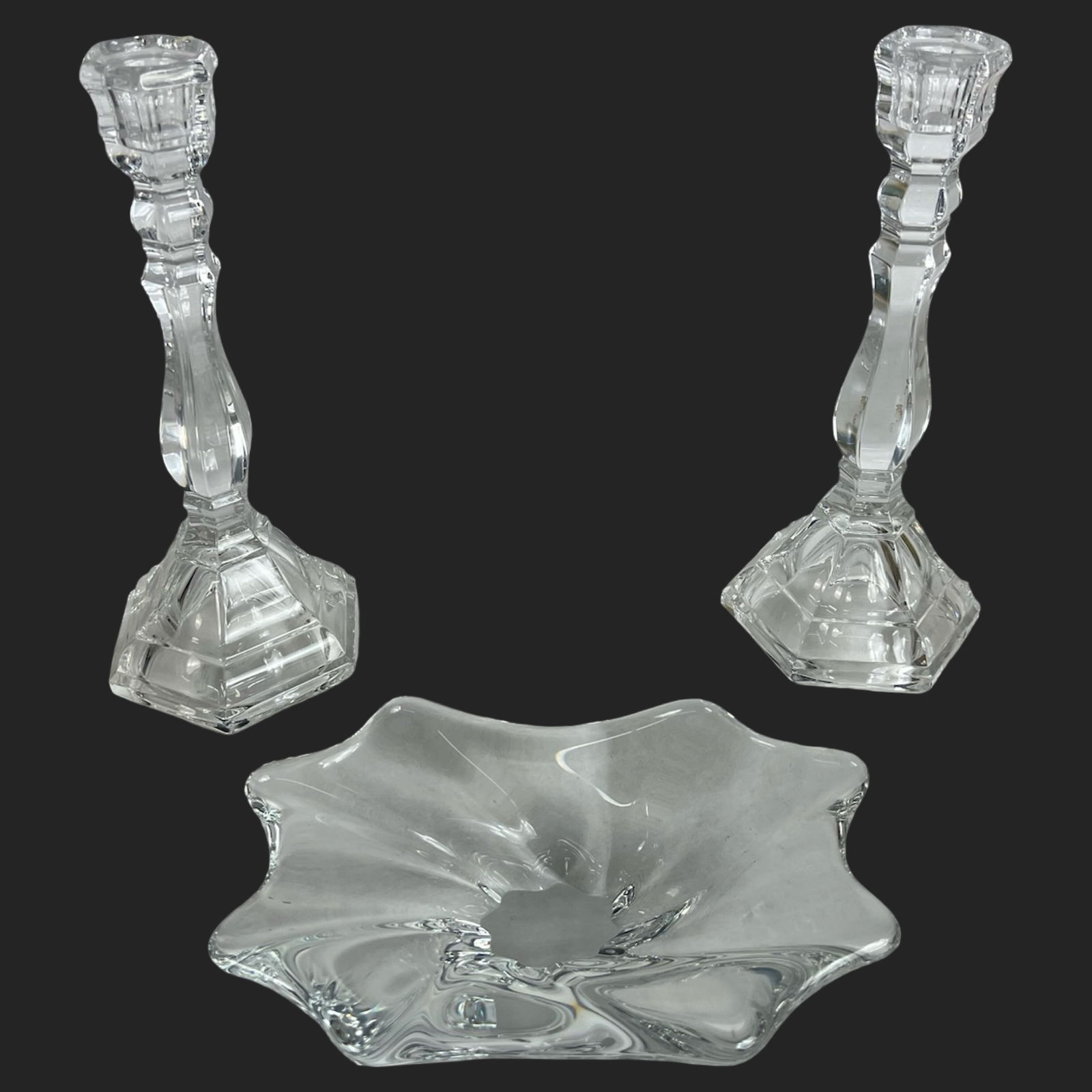 Tiffany & Co Crystal Candlesticks & Baccarat Bowl: Elegant crystal display set including a pair of Tiffany & Co. "Hampton" pattern candlesticks, each standing 9" tall with a classic faceted column and stepped hexagonal base. Accompanied by a fluidly s