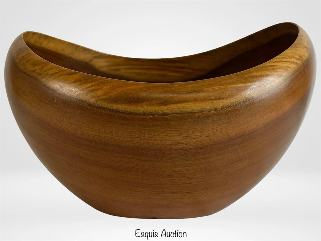 Peter M. Petrochko- Black Walnut Sculptural Bowl: Elegant and organic in form, this masterfully hand-carved sculptural bowl is crafted from rich black walnut by American wood artist Peter M. Petrochko. Dated October 1987 and signed on the underside,