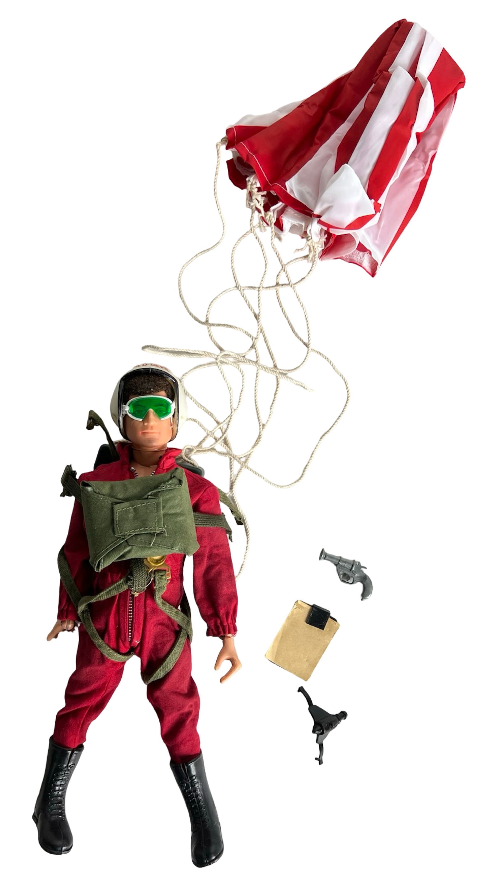 Vintage GI Joe Red Devil Paratrooper Action Figure: Vintage GI Joe action figure dressed in a red jumpsuit with black boots, helmet, and olive harness, equipped with a red-and-white parachute. Includes pistol, holster, and folder accessory. Shows light
