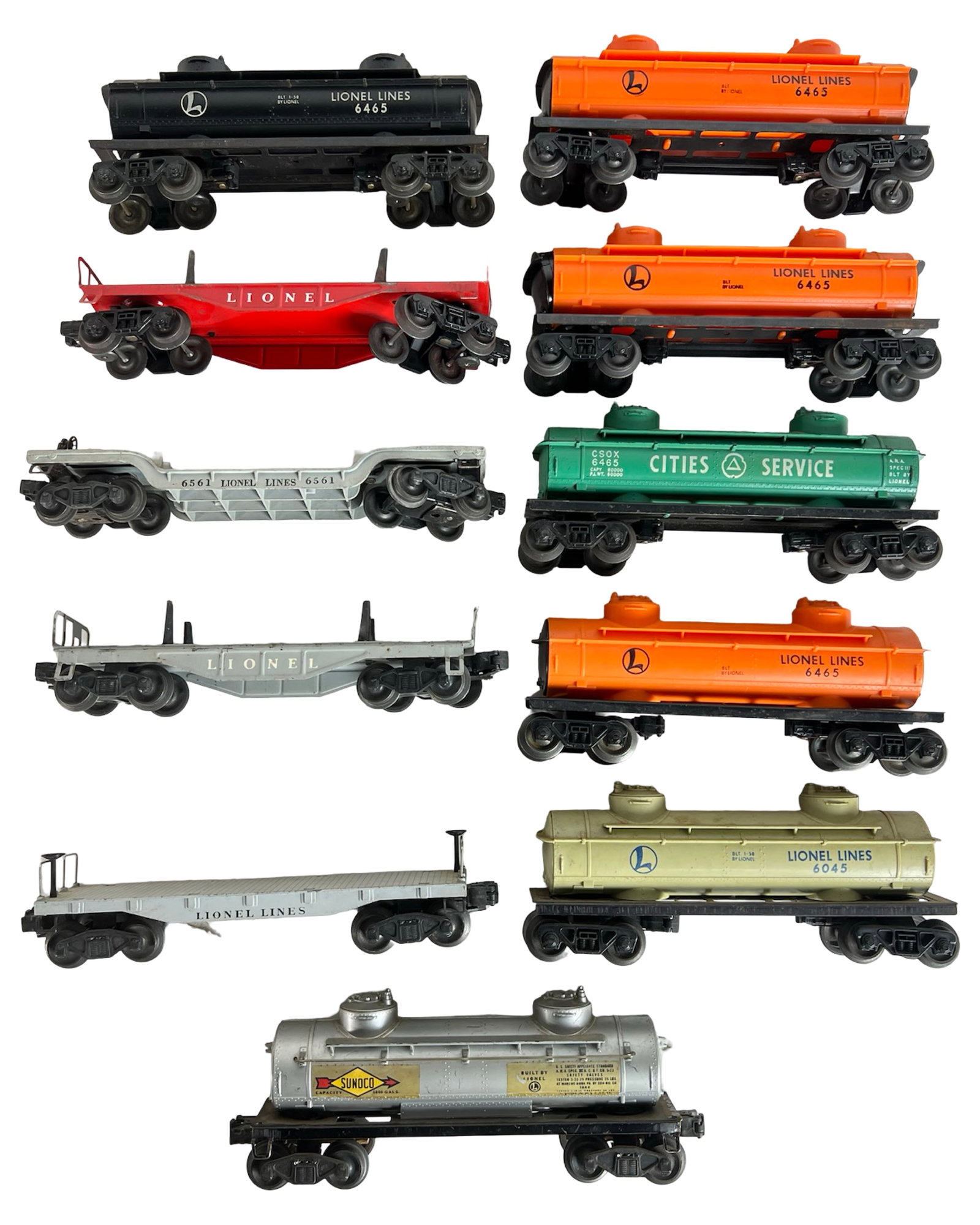 Vintage Lionel O Gauge Tank Cars & Flatcars Lot: Lot of eleven vintage Lionel O gauge freight cars, featuring multiple 6465 tanker variations in black, orange, cream, and silver, along with a Cities Service tanker and a Sunoco tanker. Also includes 