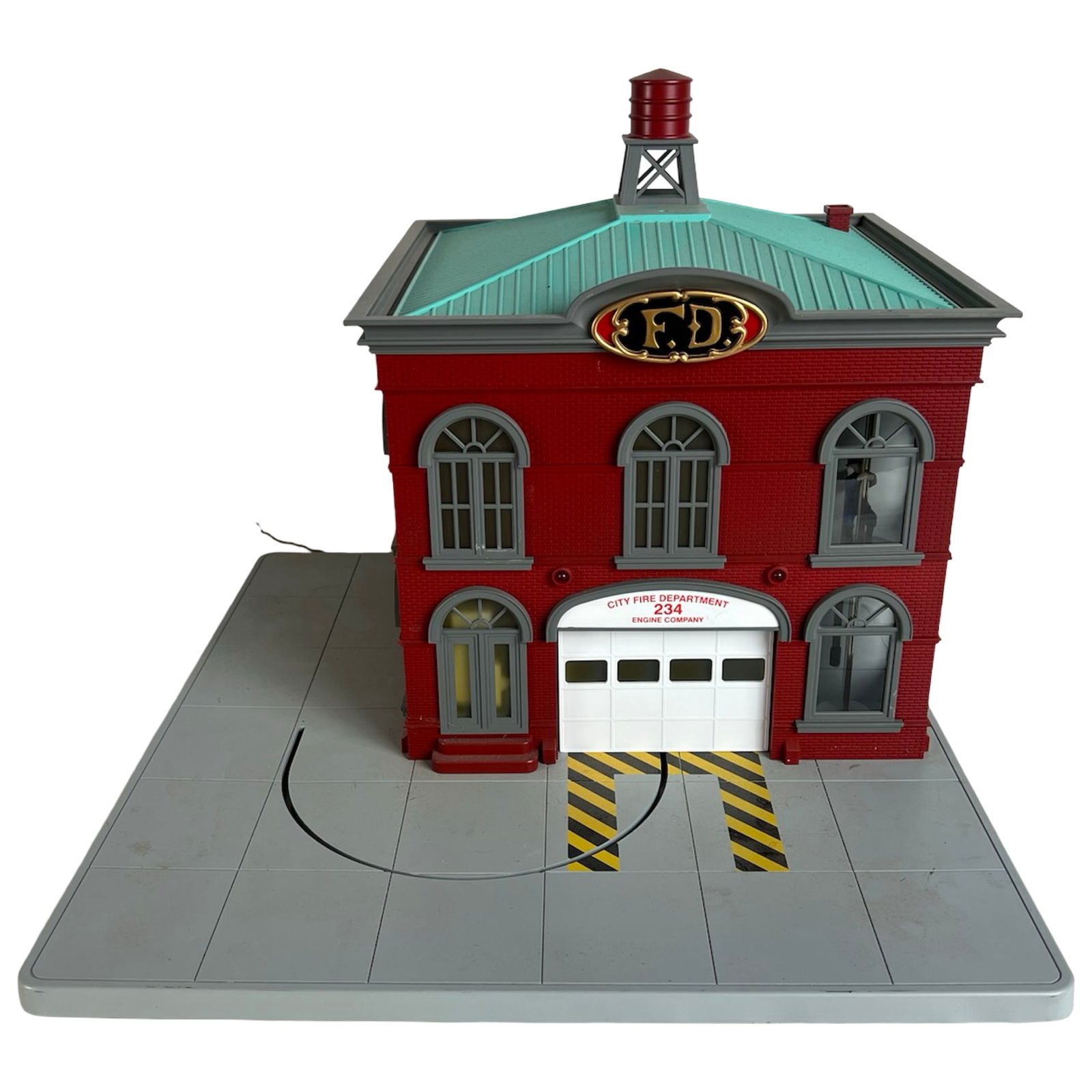 MTH RailKing Operating Firehouse 30-9102 - O Gauge: MTH RailKing Operating Firehouse, model 30-9102, designed for O Gauge layouts. Features the classic red brick firehouse façade with arched windows, rooftop water tower, and "F.D." crest. Includes ope