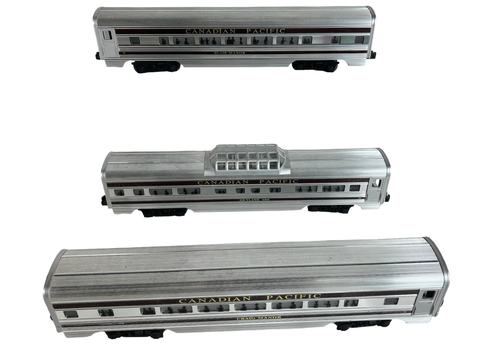 Aluminum Lionel Canadian Pacific Passenger Cars: Set of three Lionel aluminum Canadian Pacific passenger cars, including Blair Manor, Skyline 500 dome car, and Craig Manor. Each car features detailed window silhouettes, crisp lettering, and original