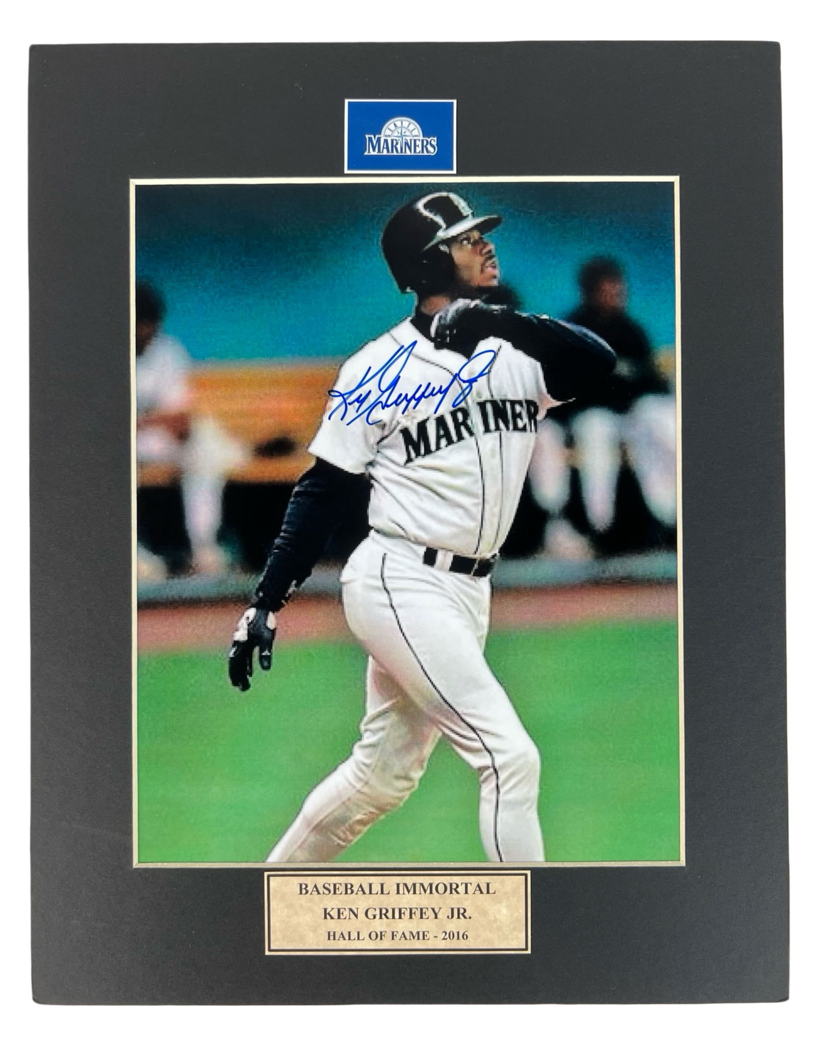 Ken Griffey Jr. Autographed Seattle Mariners Photo: Autographed Ken Griffey Jr. Seattle Mariners photograph featuring a bold signature across an iconic batting pose. Displayed in a black mat with team logo and plaque reading "Baseball Immortal - Hall o
