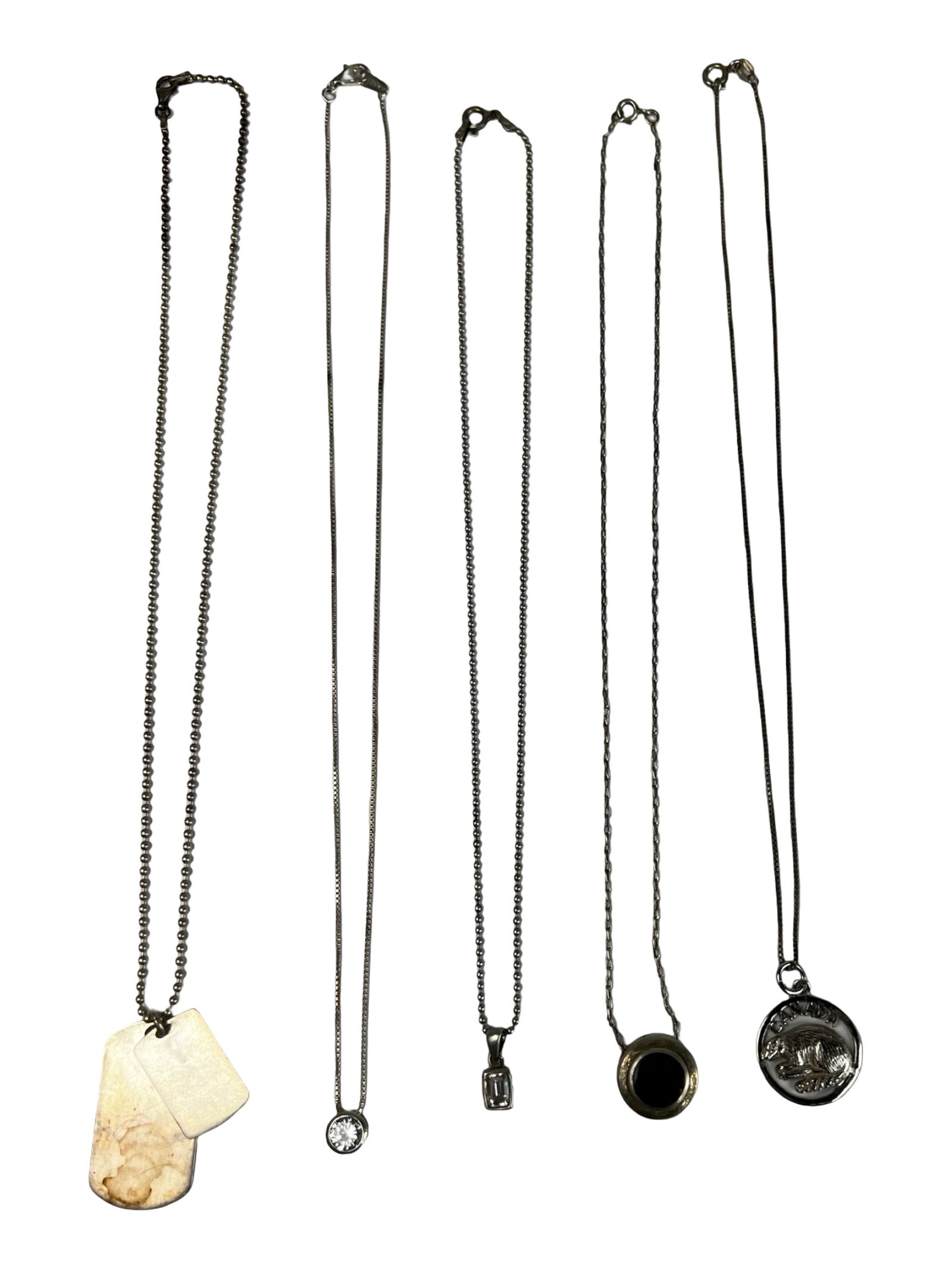 Group of Sterling Silver Necklaces: Assorted sterling silver necklaces, each approximately 16" long, featuring a variety of distinctive pendants. Includes a minimalist round CZ solitaire, rectangular step-cut CZ, black stone in a round