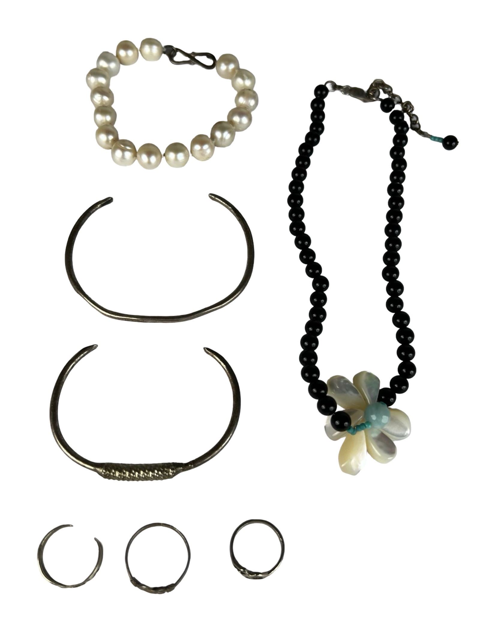 Vintage Sterling Silver & Beaded Jewelry Lot: Mixed lot of vintage jewelry featuring sterling silver and beadwork pieces. Includes two hand-hammered sterling silver cuff bracelets (approx. 2 1/2" x 2 3/4"), a 16" black beaded necklace with mother
