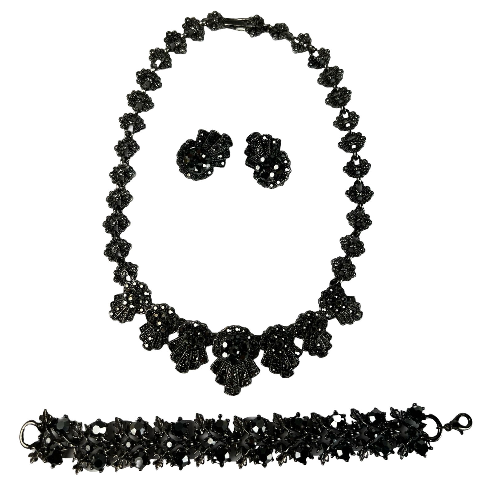Black Rhinestone Jewelry Set - Necklace, Bracelet: Elegant vintage-style costume jewelry set featuring a 17" fan-motif necklace, 7" dimensional link bracelet, and a pair of clip-on earrings. Each piece is adorned with glossy black rhinestones in ornat