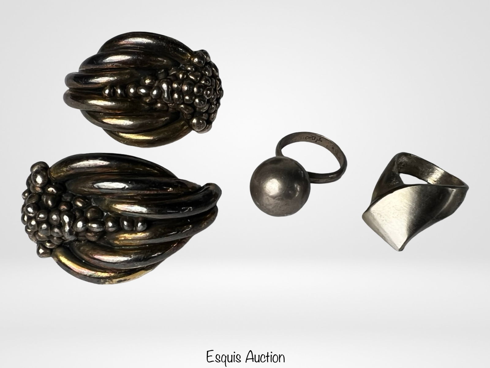 Sterling Silver Taxco Earrings & Modernist Rings: Group of three bold sterling silver pieces including a large pair of vintage Mexican Taxco clip-on earrings with sculptural beaded design ( 2.25" x 1.25"), a modernist sterling dome ring (size 6), and
