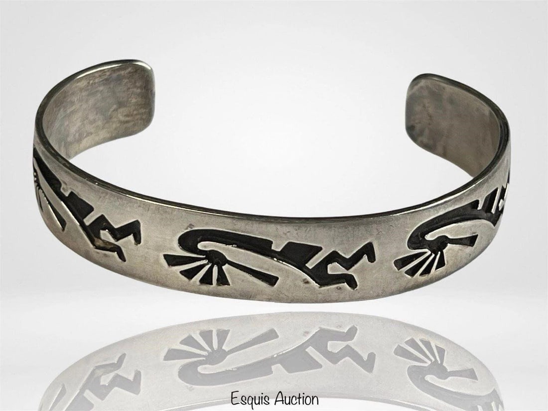 Navajo Jonathan Nez Kokopelli Sterling Bracelet: Beautifully handcrafted by Navajo silversmith Jonathan Nez, this sterling silver cuff bracelet features an etched Kokopelli design, a symbol of fertility, joy, and music in Native American culture. Th
