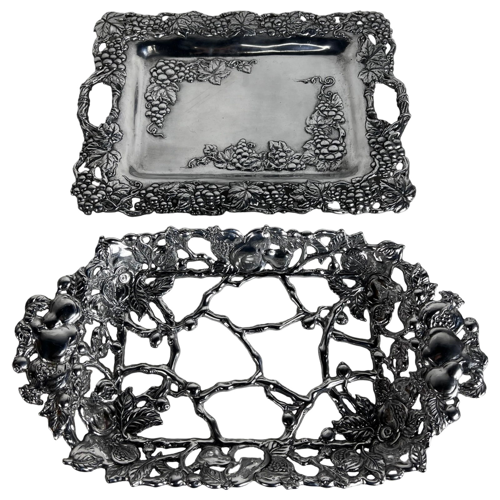Arthur Court Grape Pattern Aluminum Serveware: Pair of decorative aluminum alloy serving trays by Arthur Court, featuring the signature grapevine motif. Includes one Grape Clutch Tray measuring approximately 18" x 14" and one Open Vine Rectangular