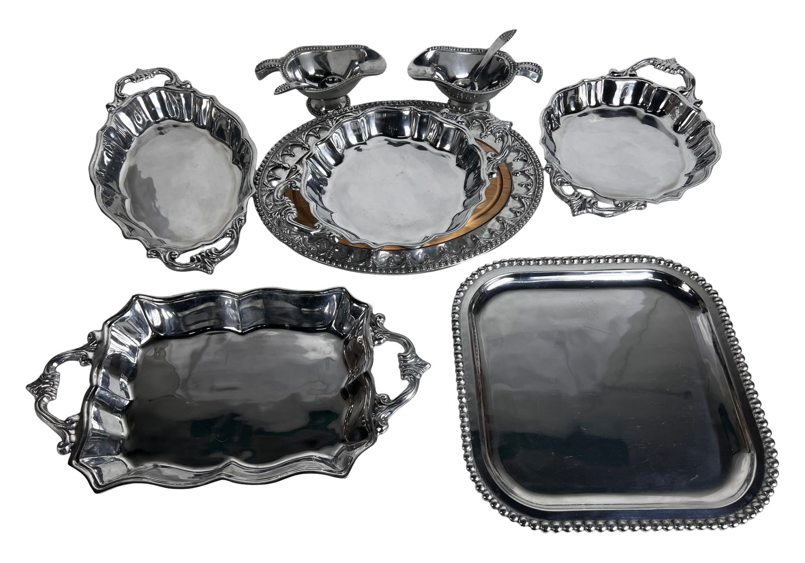 Lot of Mariposa & Beatriz Ball Aluminum Serveware: Extensive group of heavy cast aluminum serveware including Mariposa pieces and Beatriz Ball's Western Antler collection. The lot features multiple handled and handled-less trays in various forms-scall