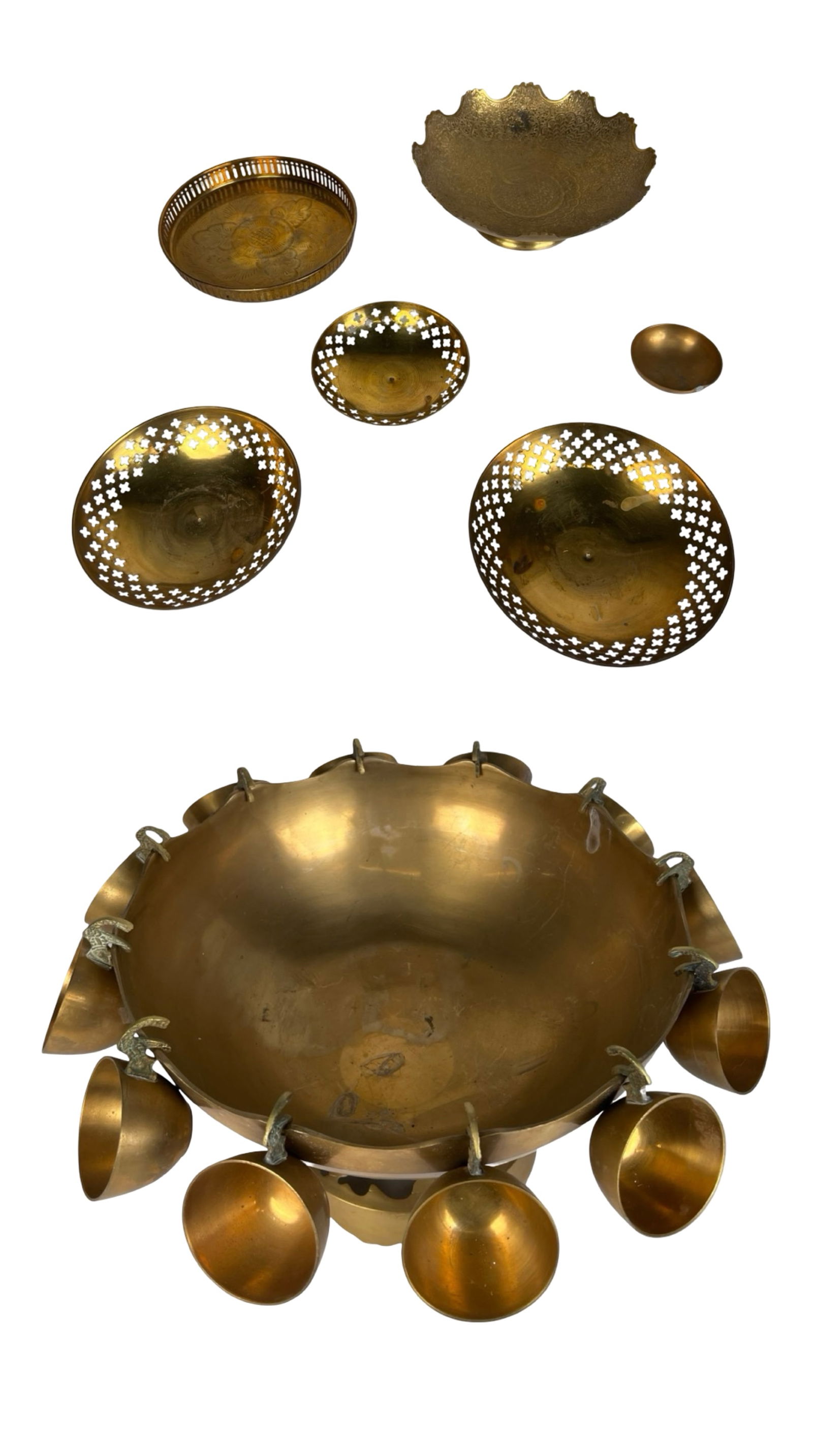 Vintage Brass Punch Bowl Set & Brass Bowls: Mid-century mixed grouping of vintage solid brass serveware, including an impressive footed punch bowl with 12 hanging cups, each suspended from ornate cast elephant-head hooks. The punch bowl feature